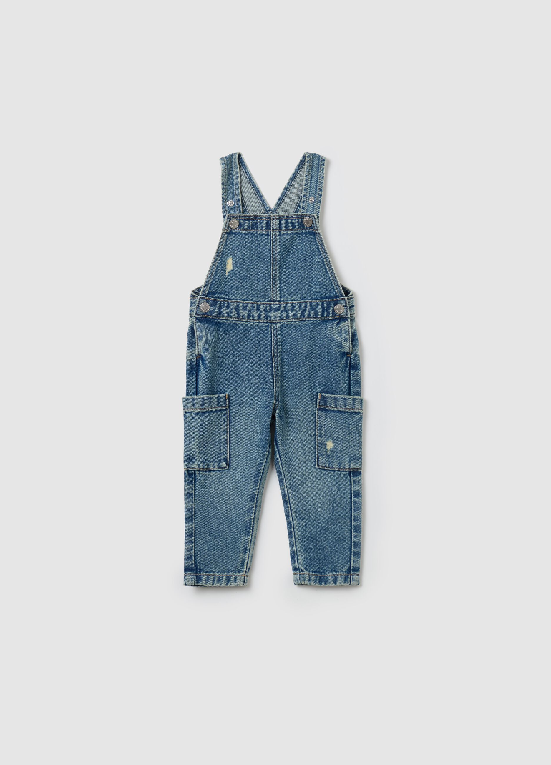 Salopette in denim con abrasioni