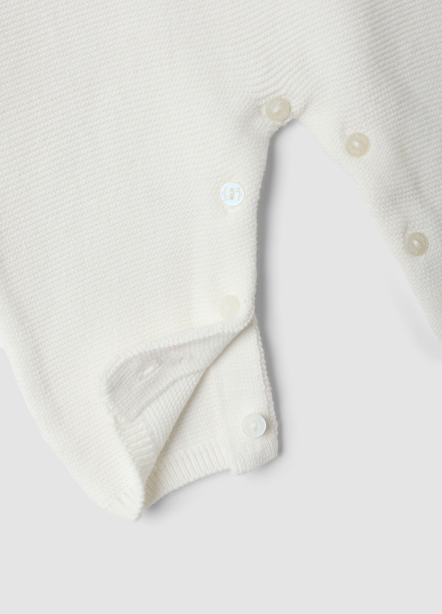 White organic cotton baby sleepsuit with cable knit detail