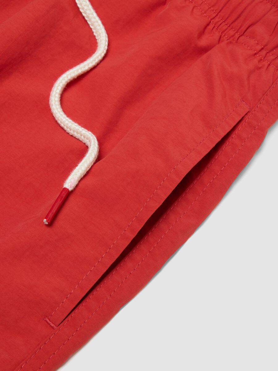 Red swim shorts with elasticated waistband and drawstring_5