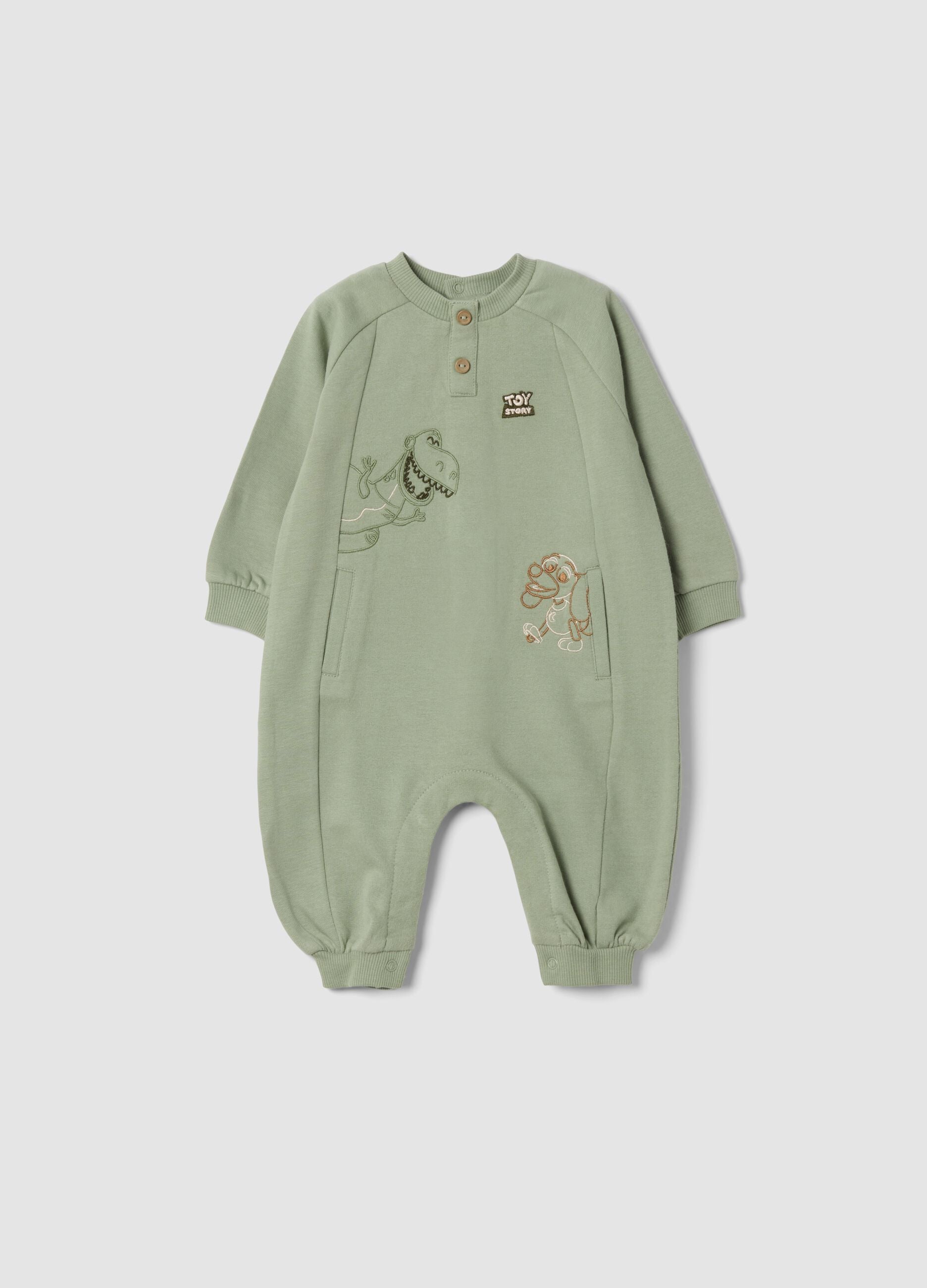 Green organic cotton sleepsuit with Toy Story print