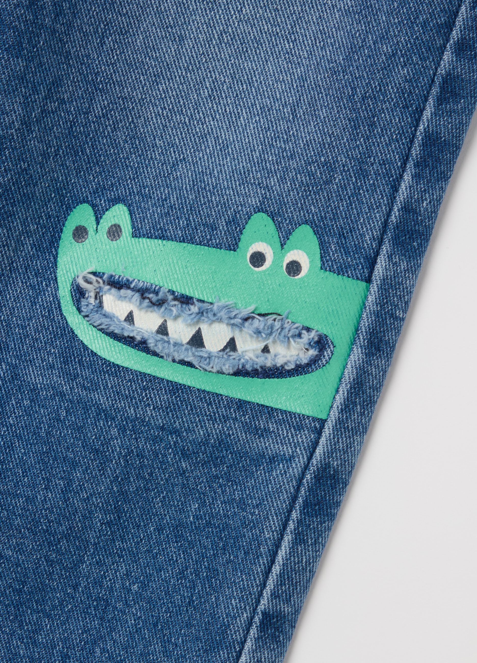 Five-pocket jeans with crocodiles print
