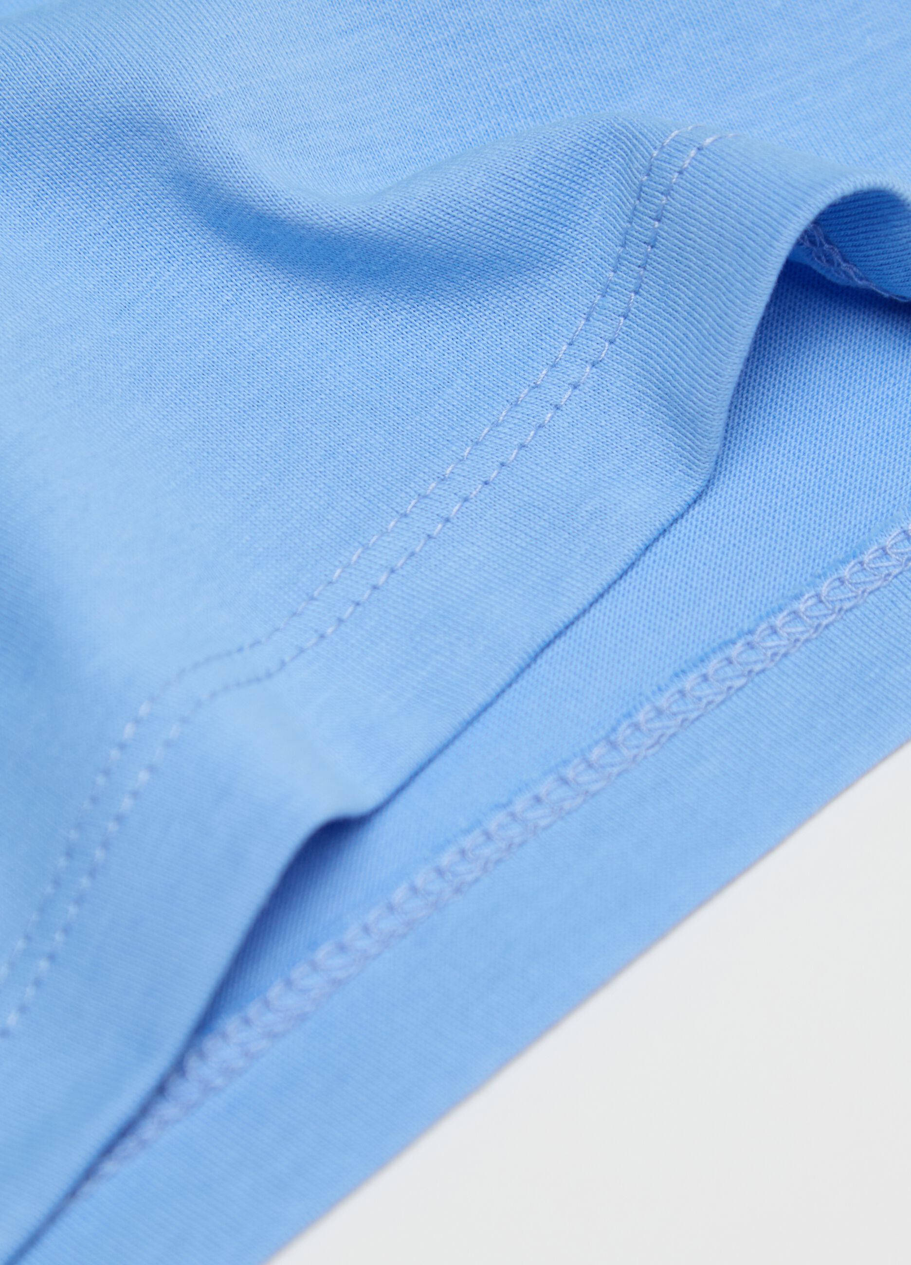 Two-pack white and light blue racerback vests in organic cotton