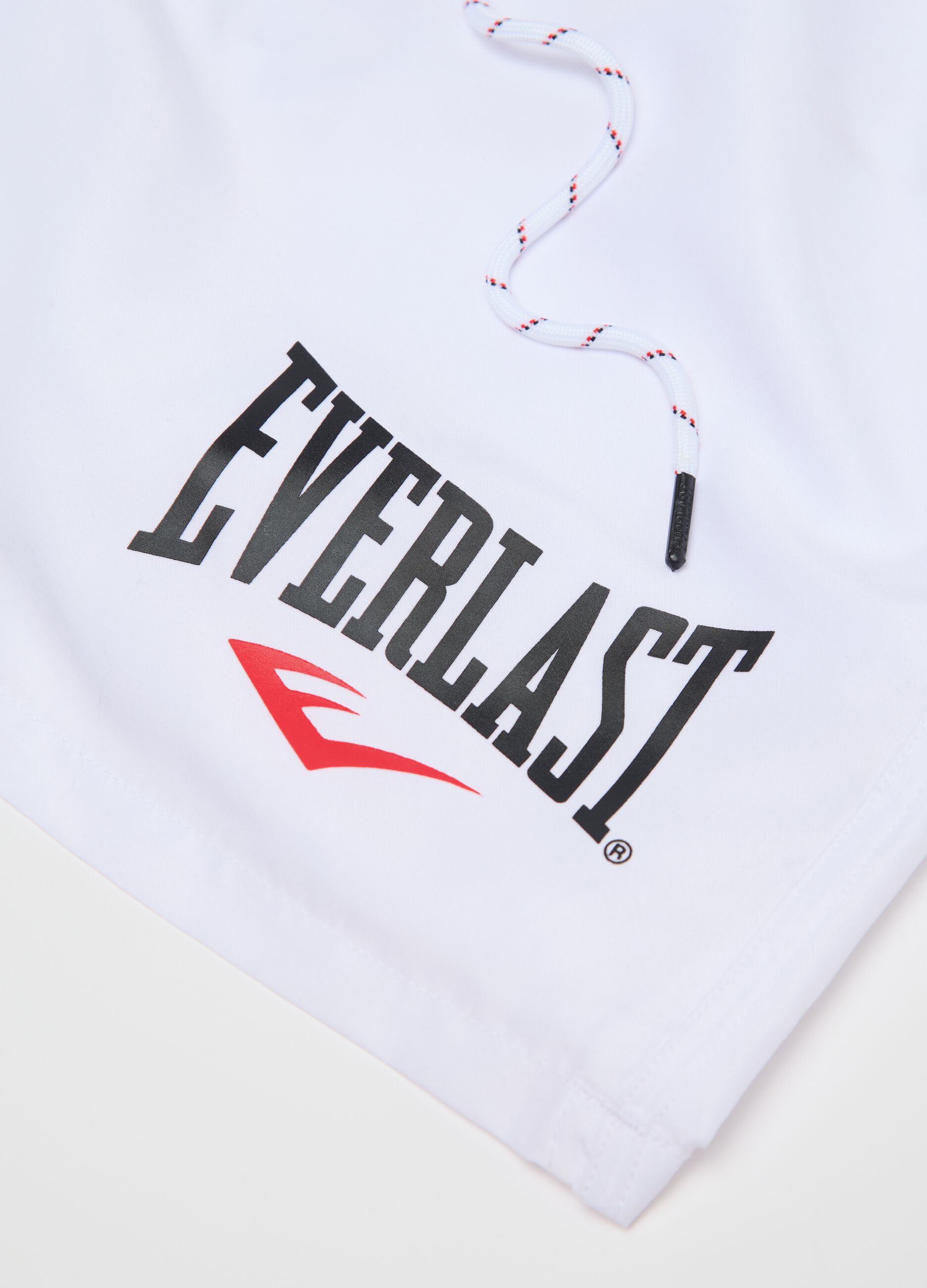 White swimming trunks with logo print