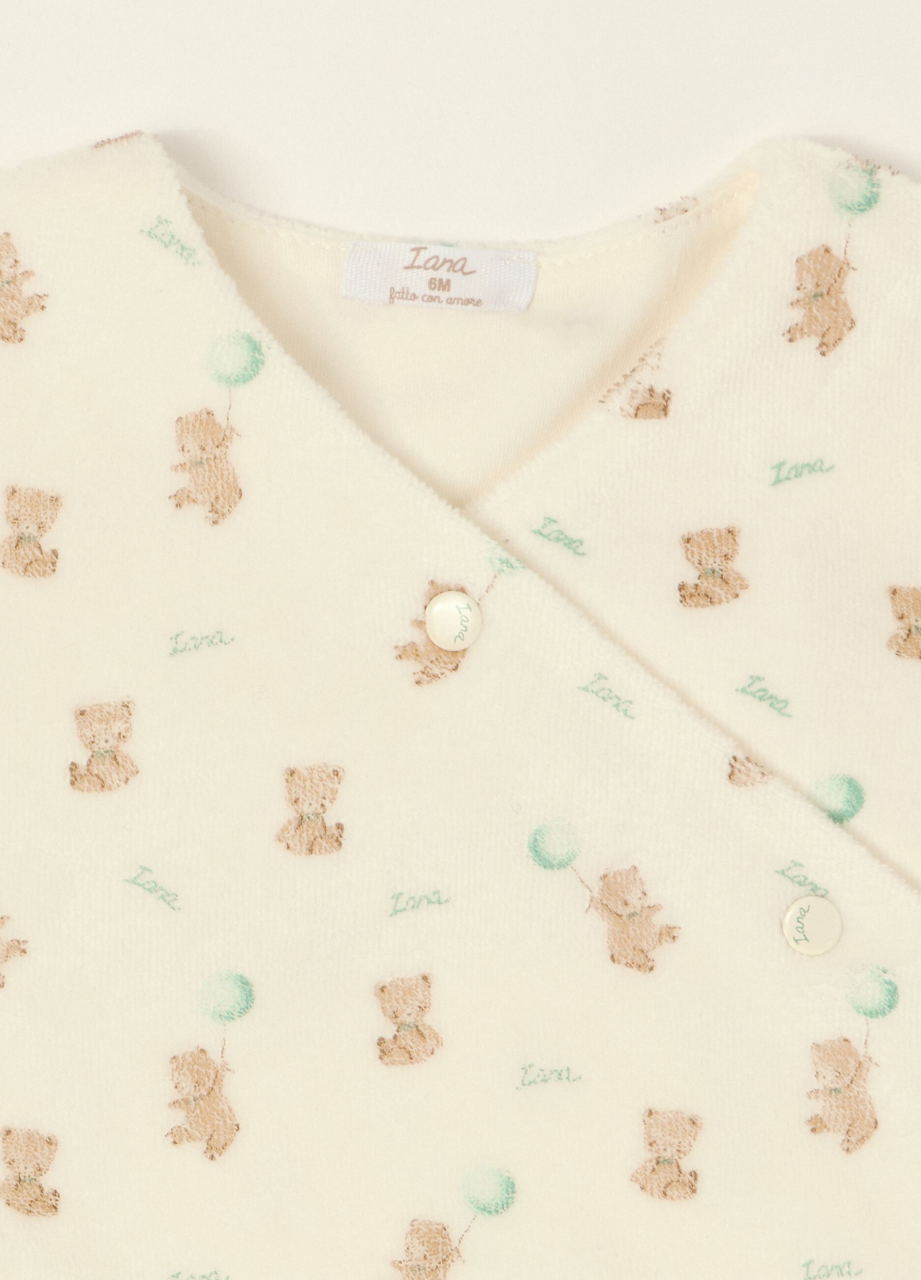 White baby sleepsuit with teddy bear print
