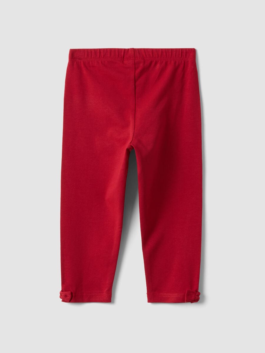 Leggings rossi in cotone organico elasticizzato con fiocchi per bimba_1