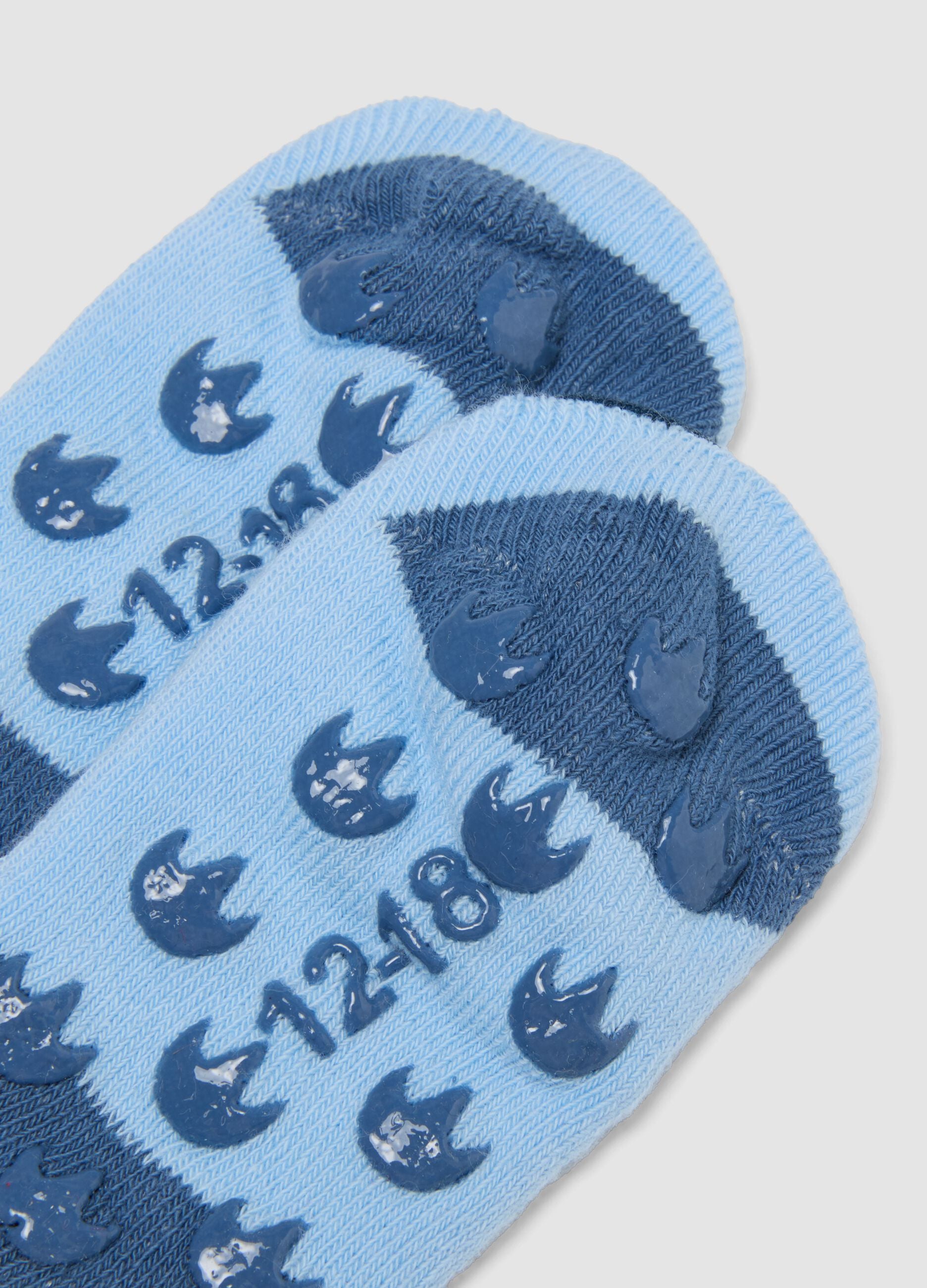 Calze antiscivolo azzurre in cotone organico elasticizzato con dinosauro