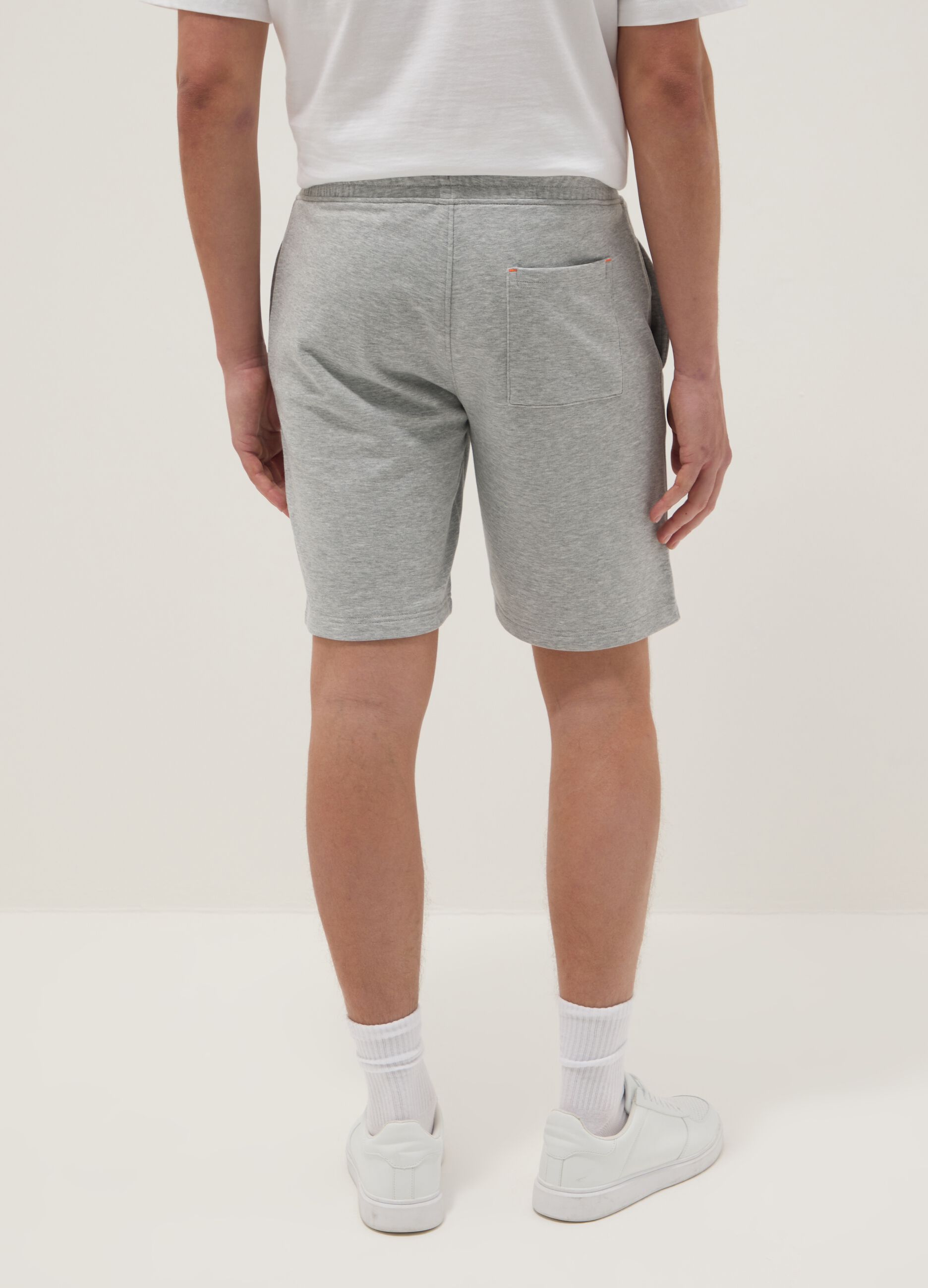 Grey shorts with orange drawstring