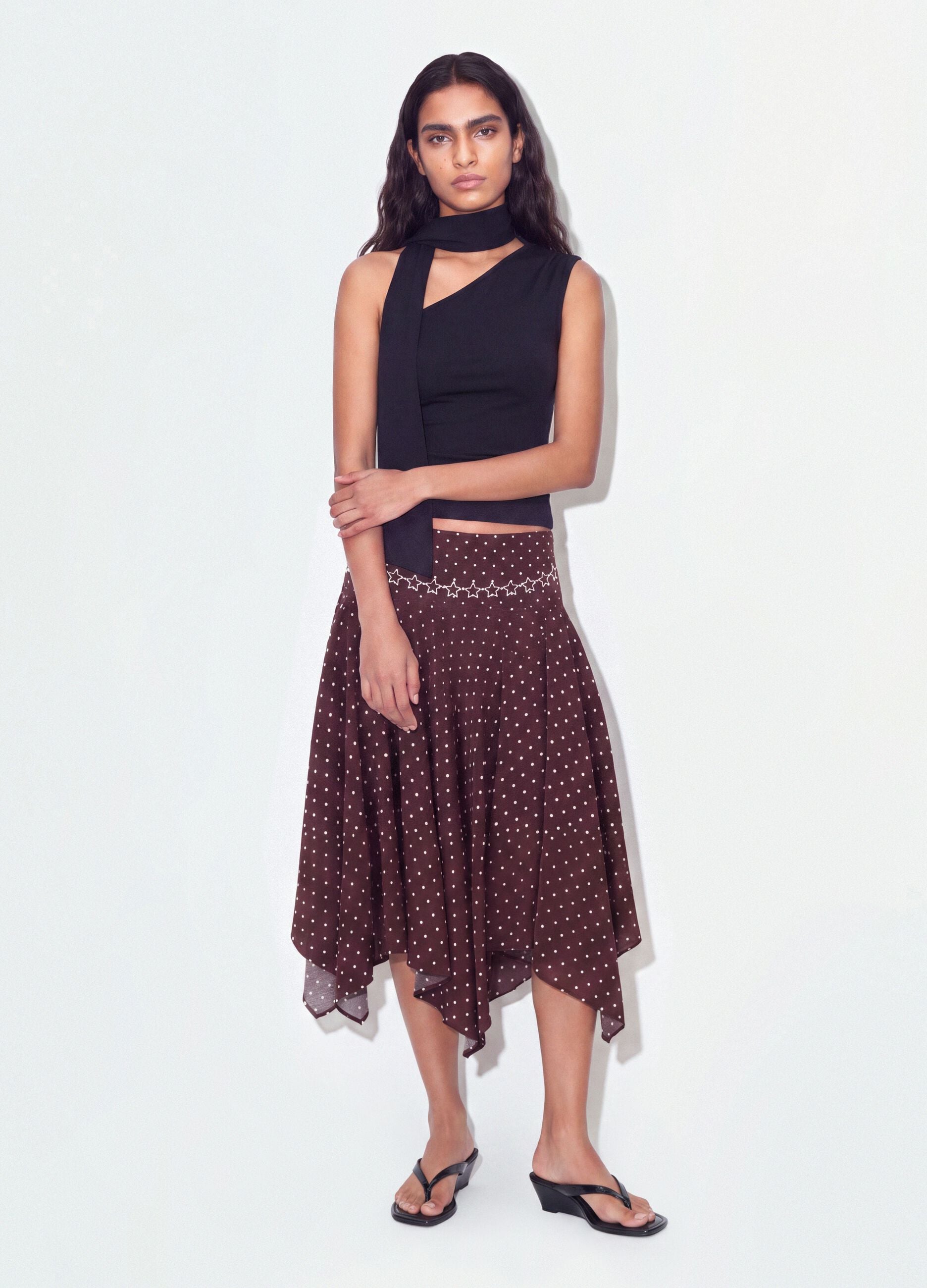 Black stretch top with asymmetric neckline and draped band