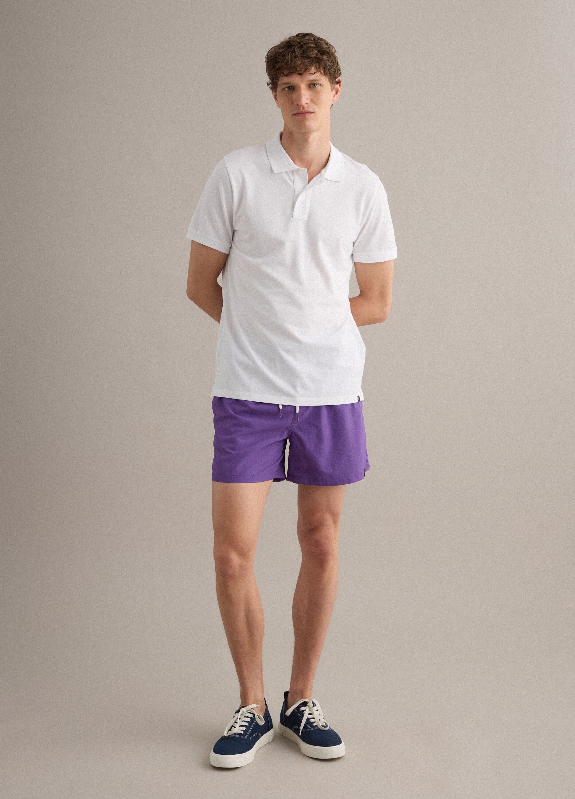 Purple swim shorts with elasticated waistband and drawstring