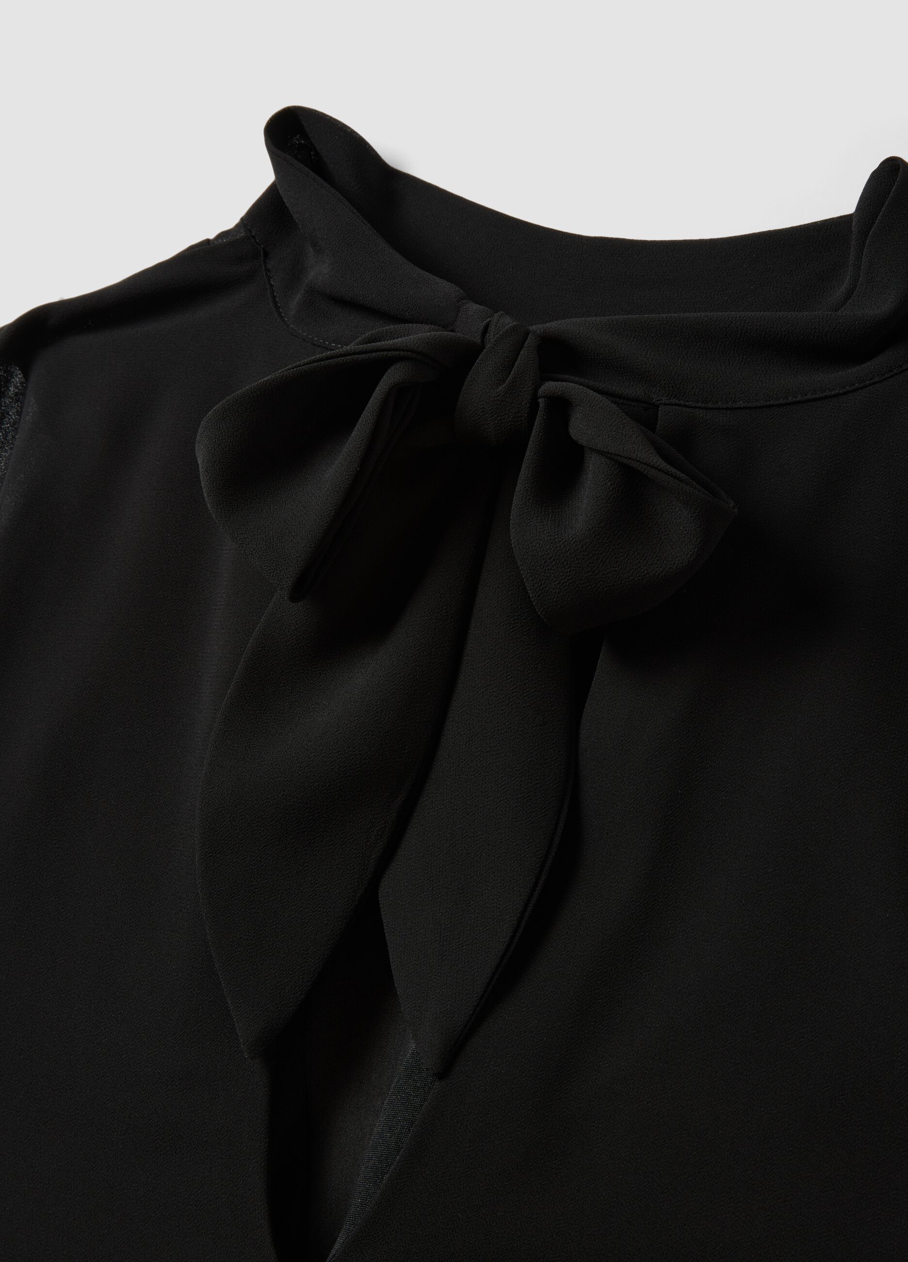 Black sleeveless high-neck slim-fit dress with bow