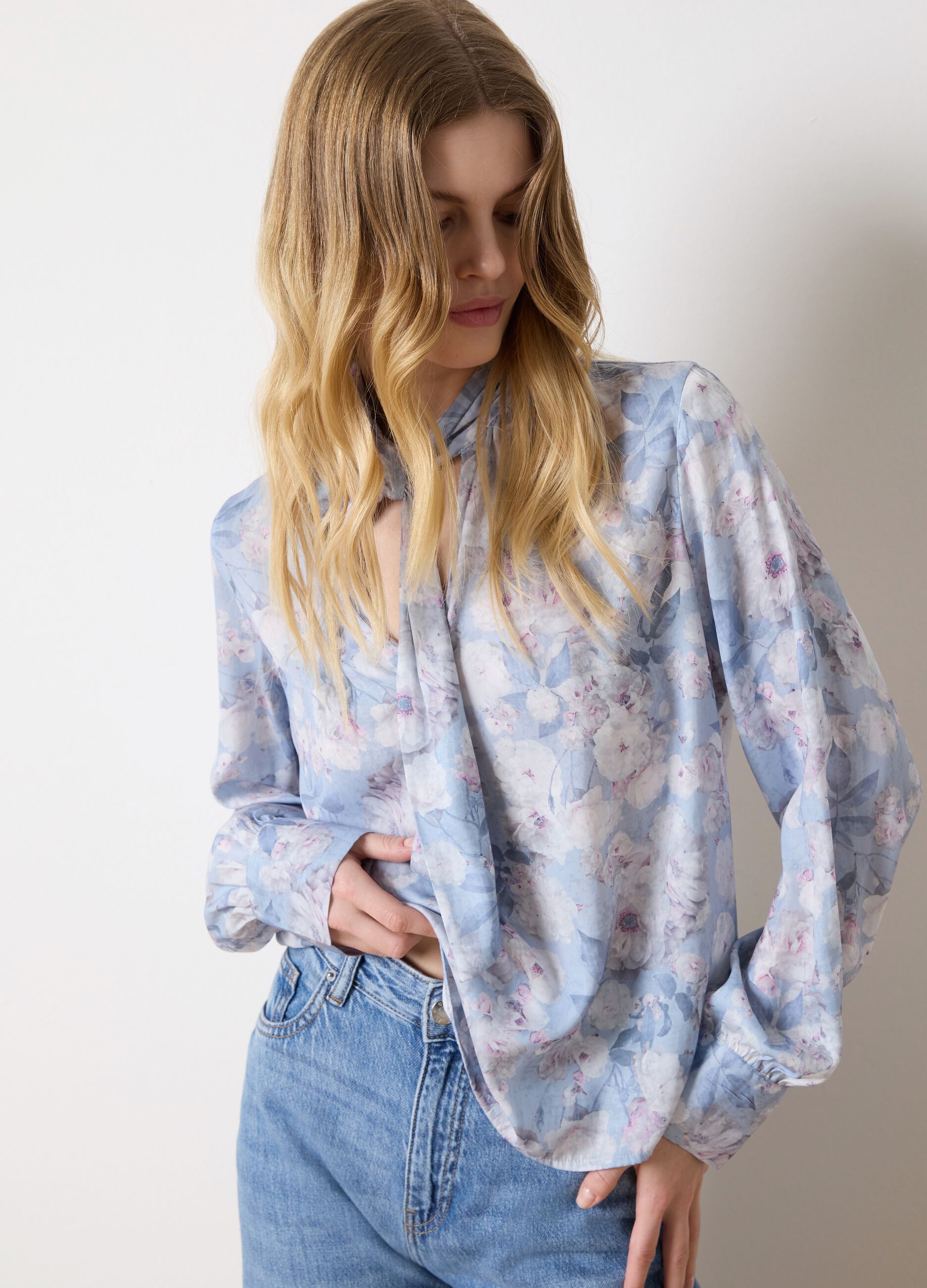 Light blue blouse with floral pattern and bow