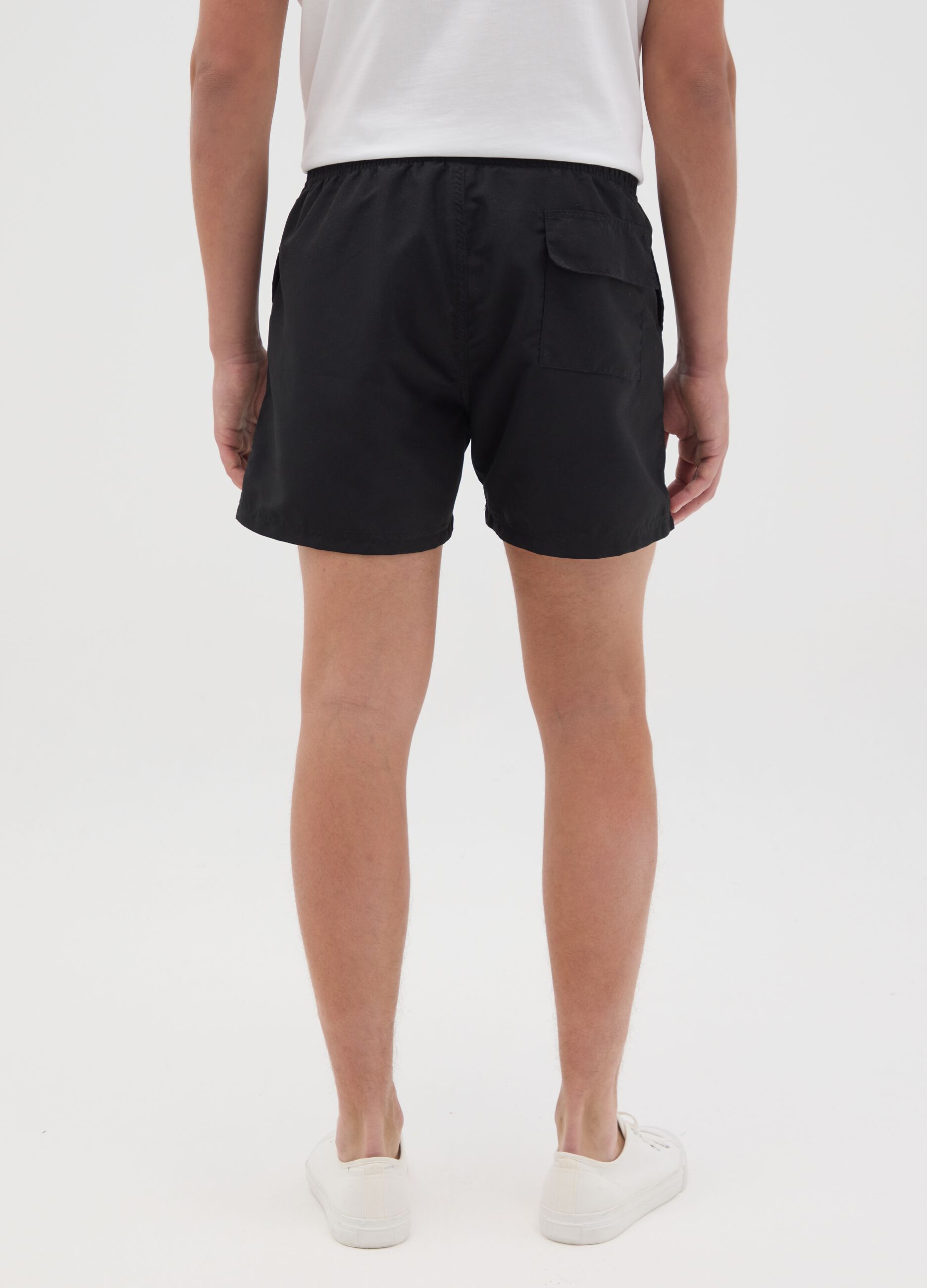 Black swimming trunks with Nirvana logo