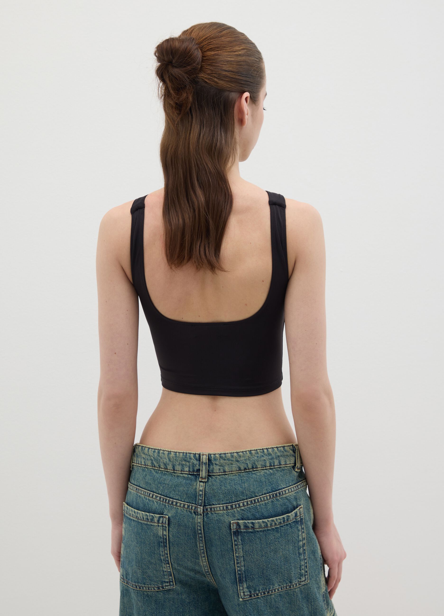 Women’s fitted top in black stretch fabric with wide straps