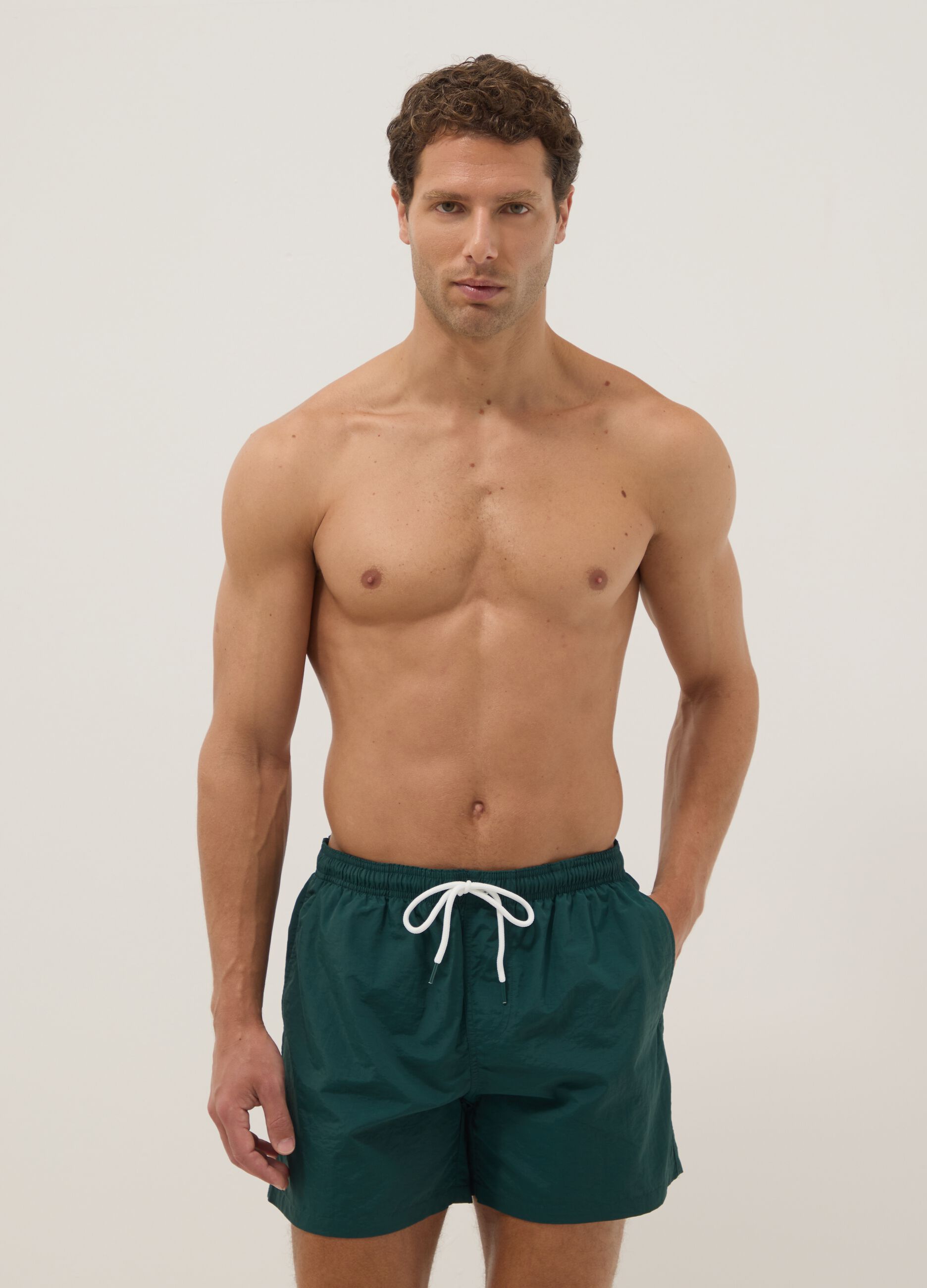 Green swim shorts with elasticated waistband