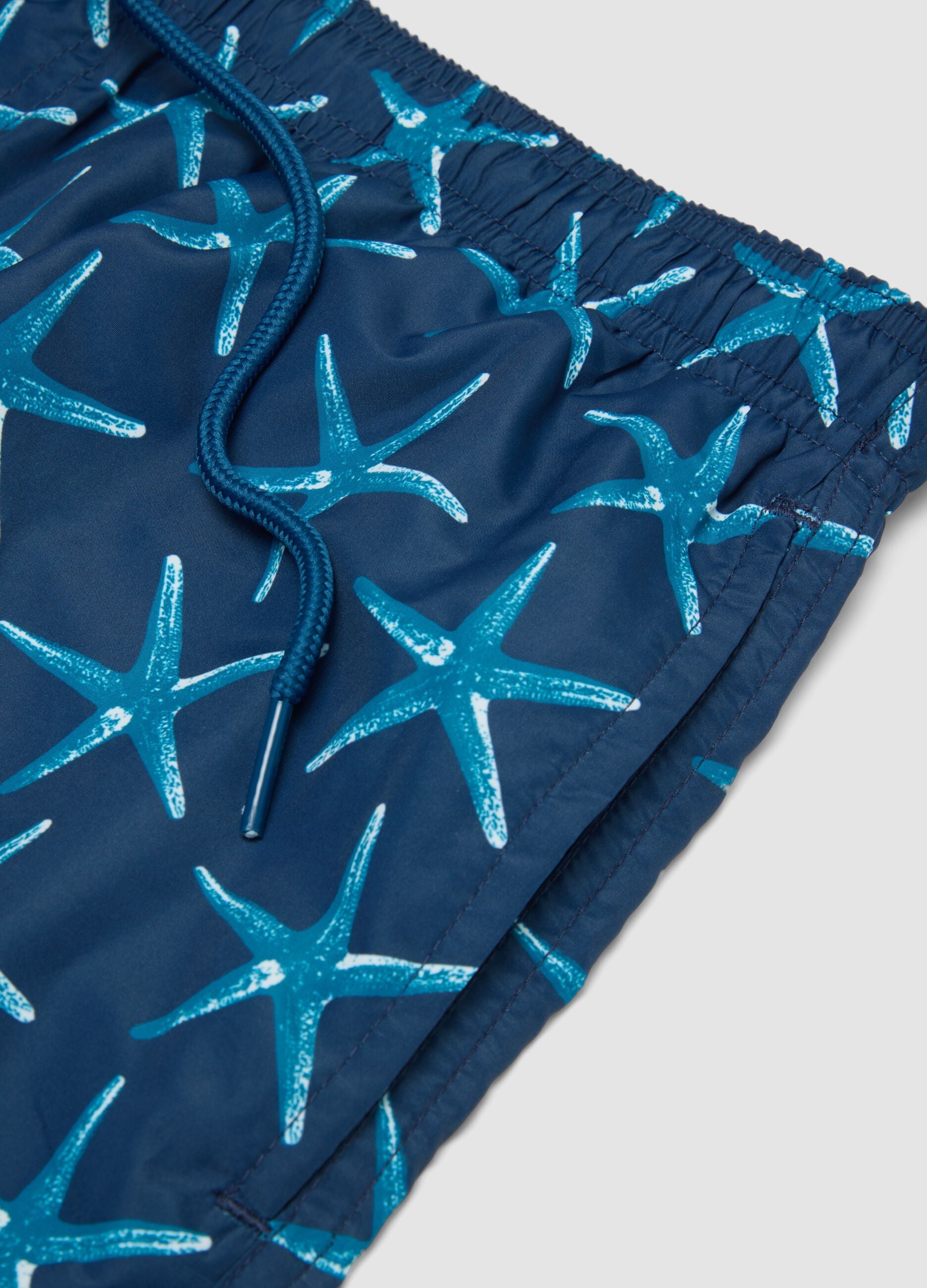 Blue boxer swim shorts with starfish print