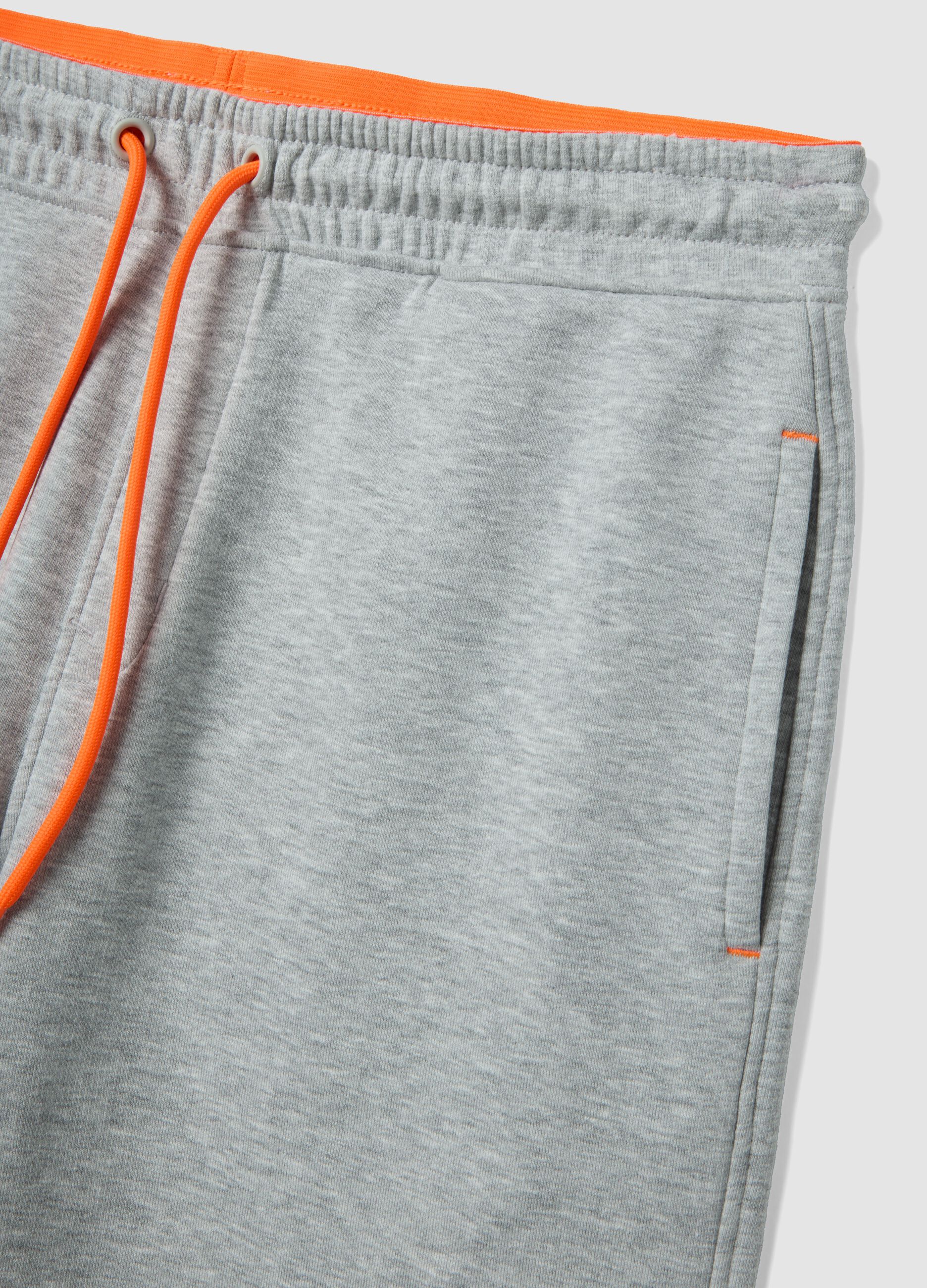 Grey shorts with orange drawstring