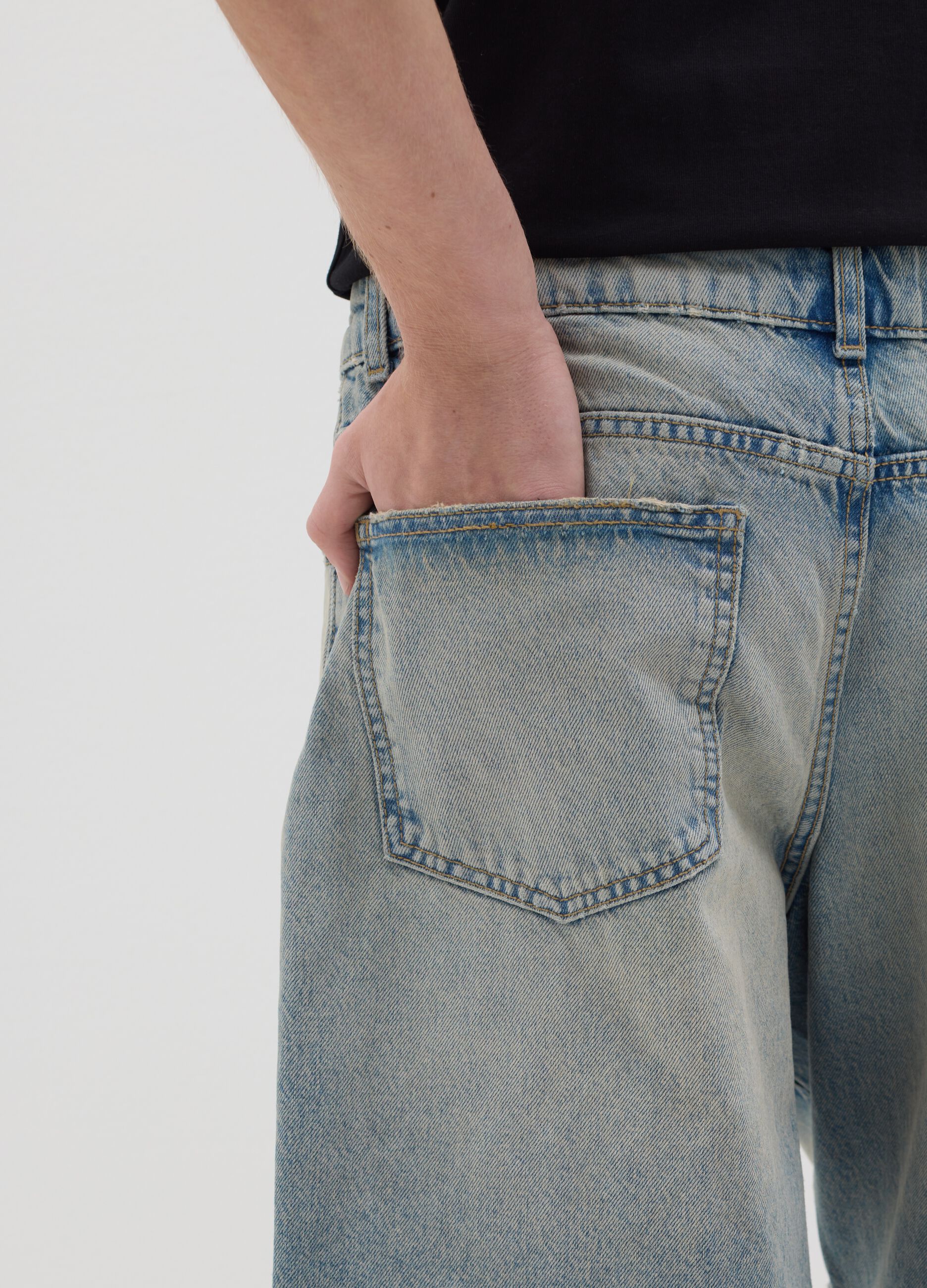 Light blue denim shorts with ripped details