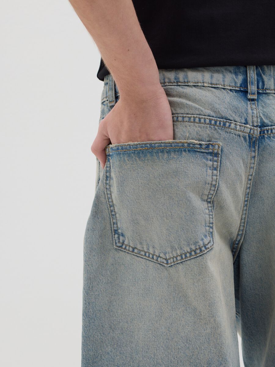 Light blue denim shorts with ripped details_3