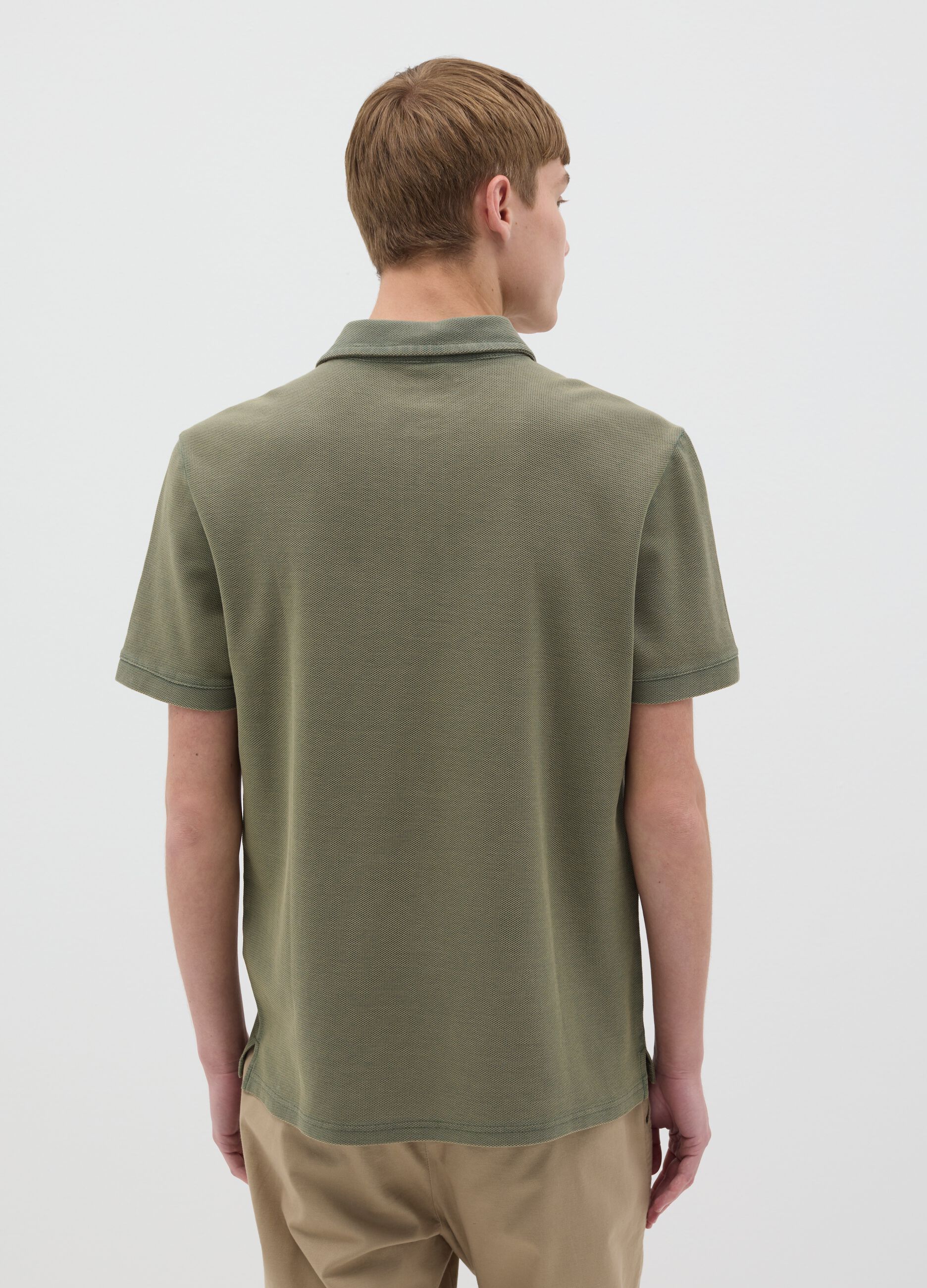 Green short-sleeved polo shirt in cotton piquet