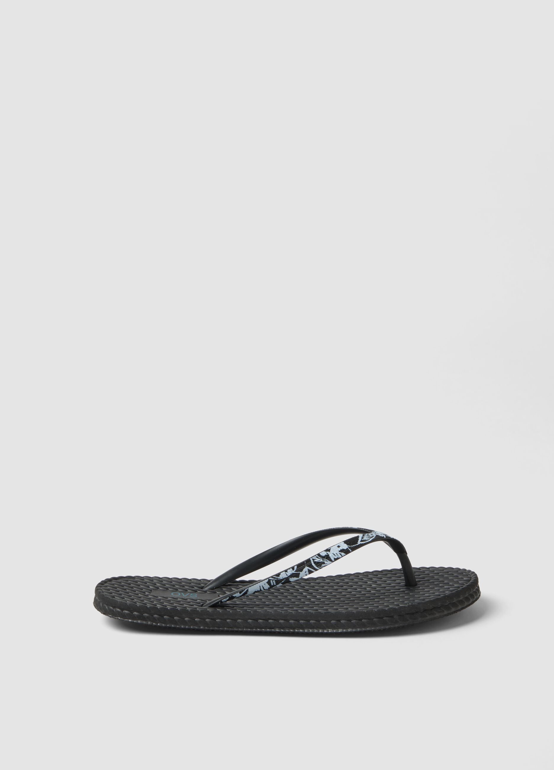 Black flip-flops with embellished straps and braided texture