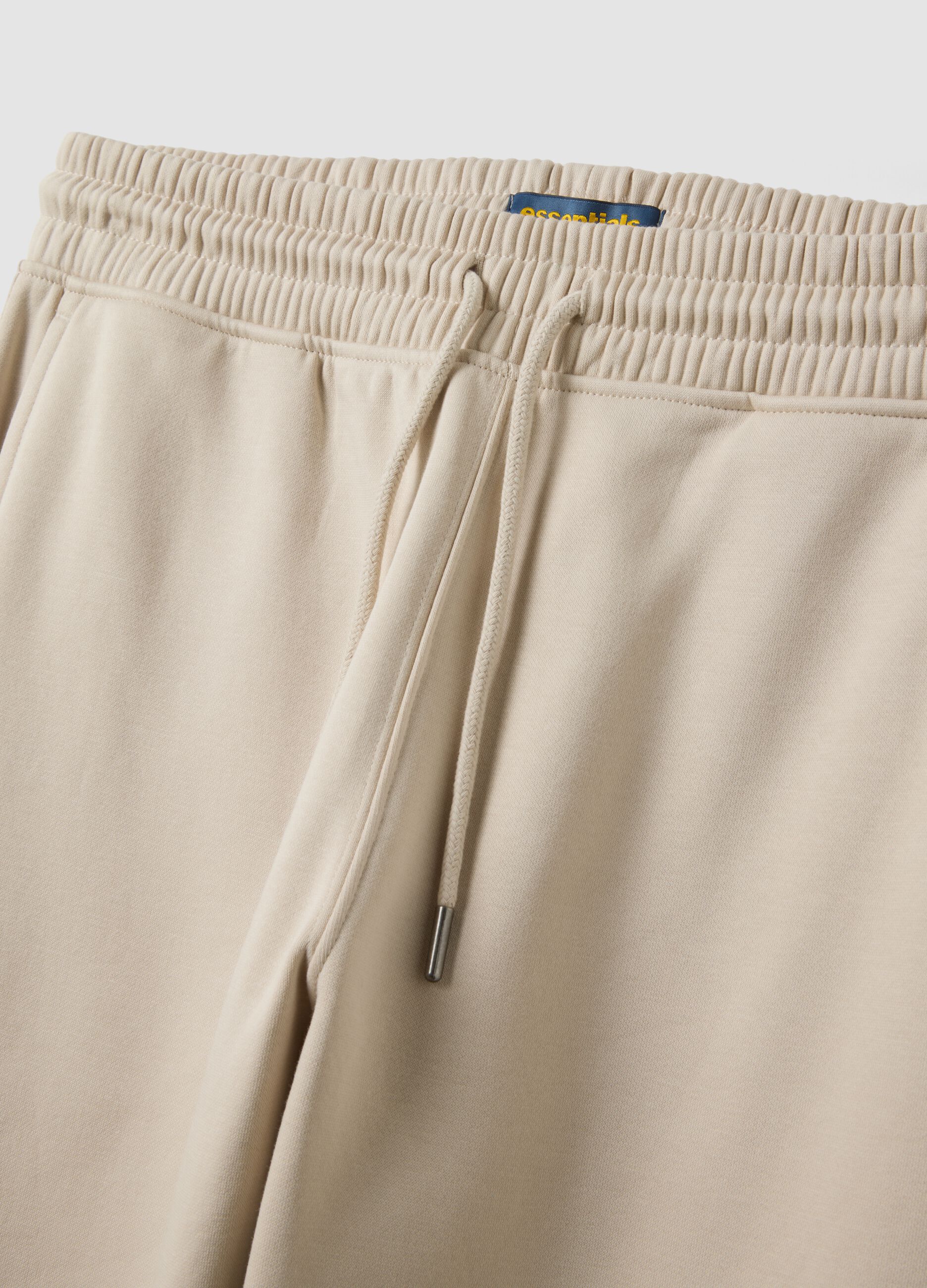 Beige cotton-blend joggers with cuffed hems and drawstring