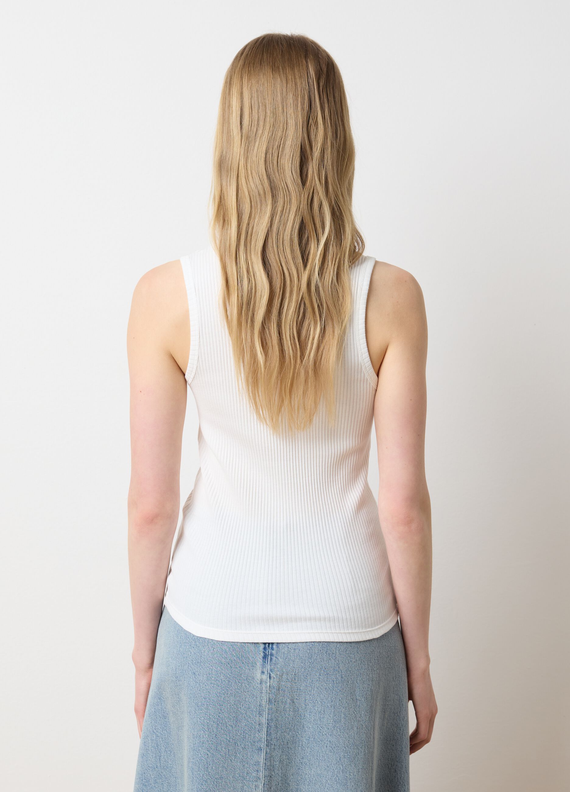 Top bianco a costine con applicazioni floreali