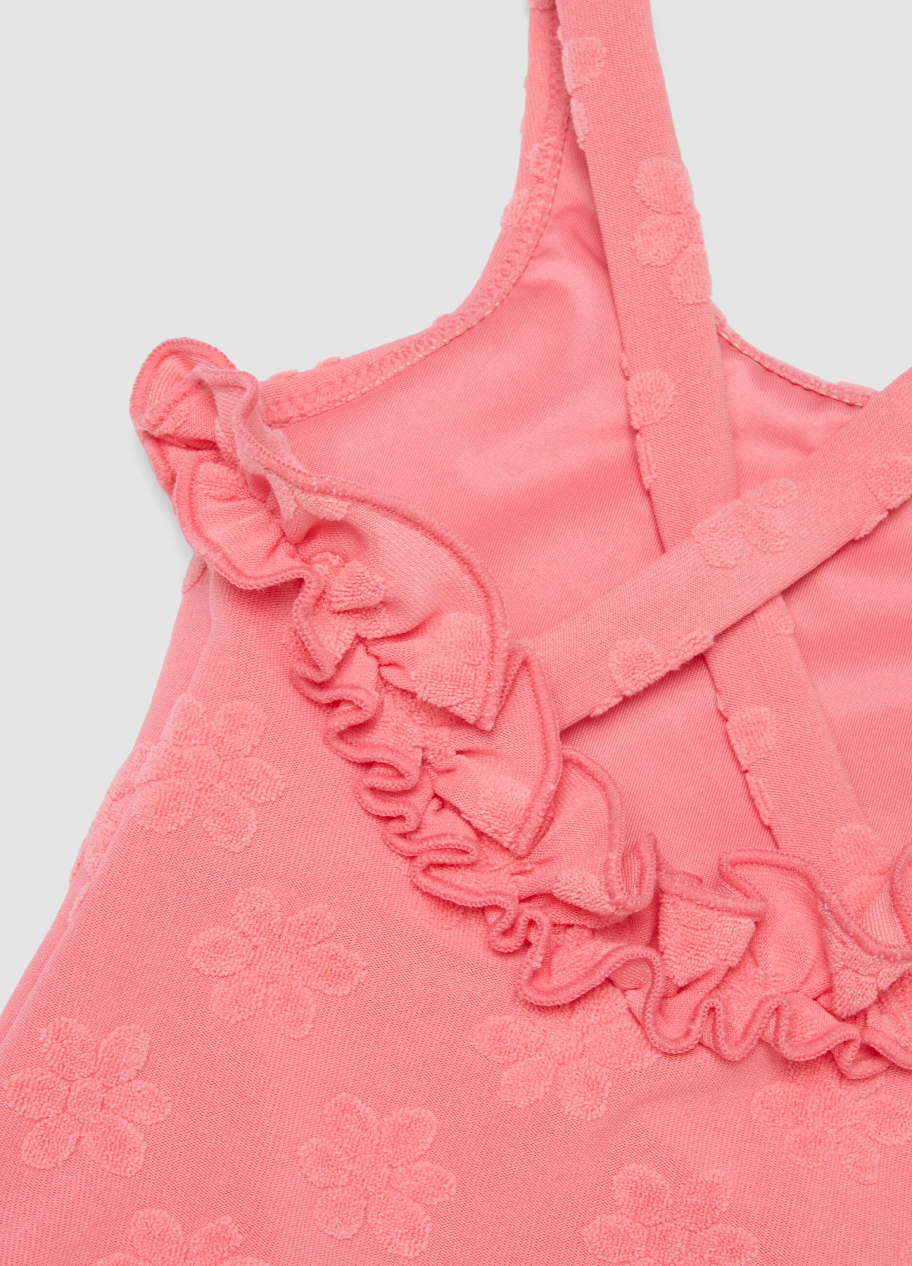 Pink stretch-fabric one-piece swimsuit for baby girls with floral detailing