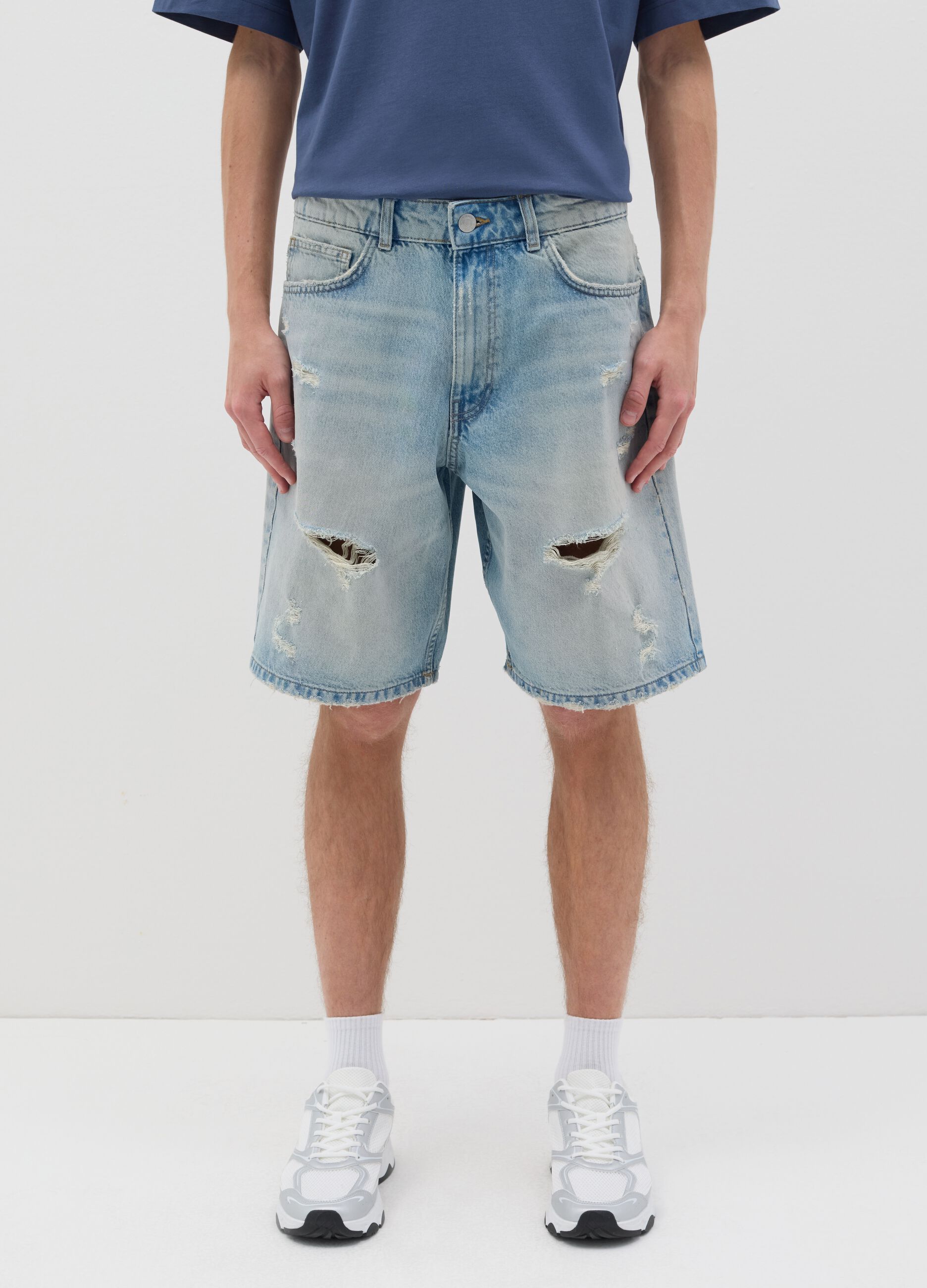 Blue denim shorts with ripped details