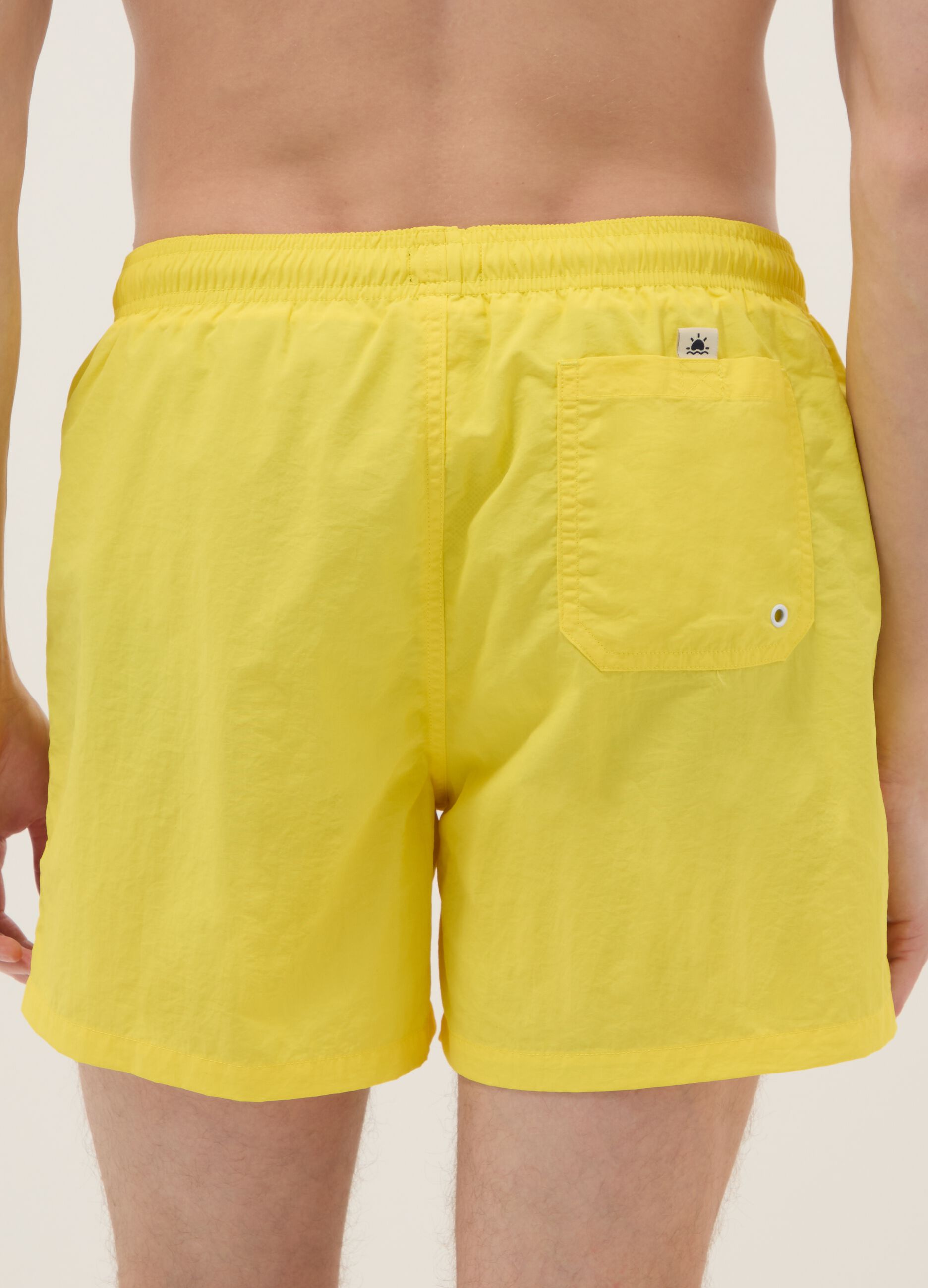 Yellow swim shorts with elasticated waistband
