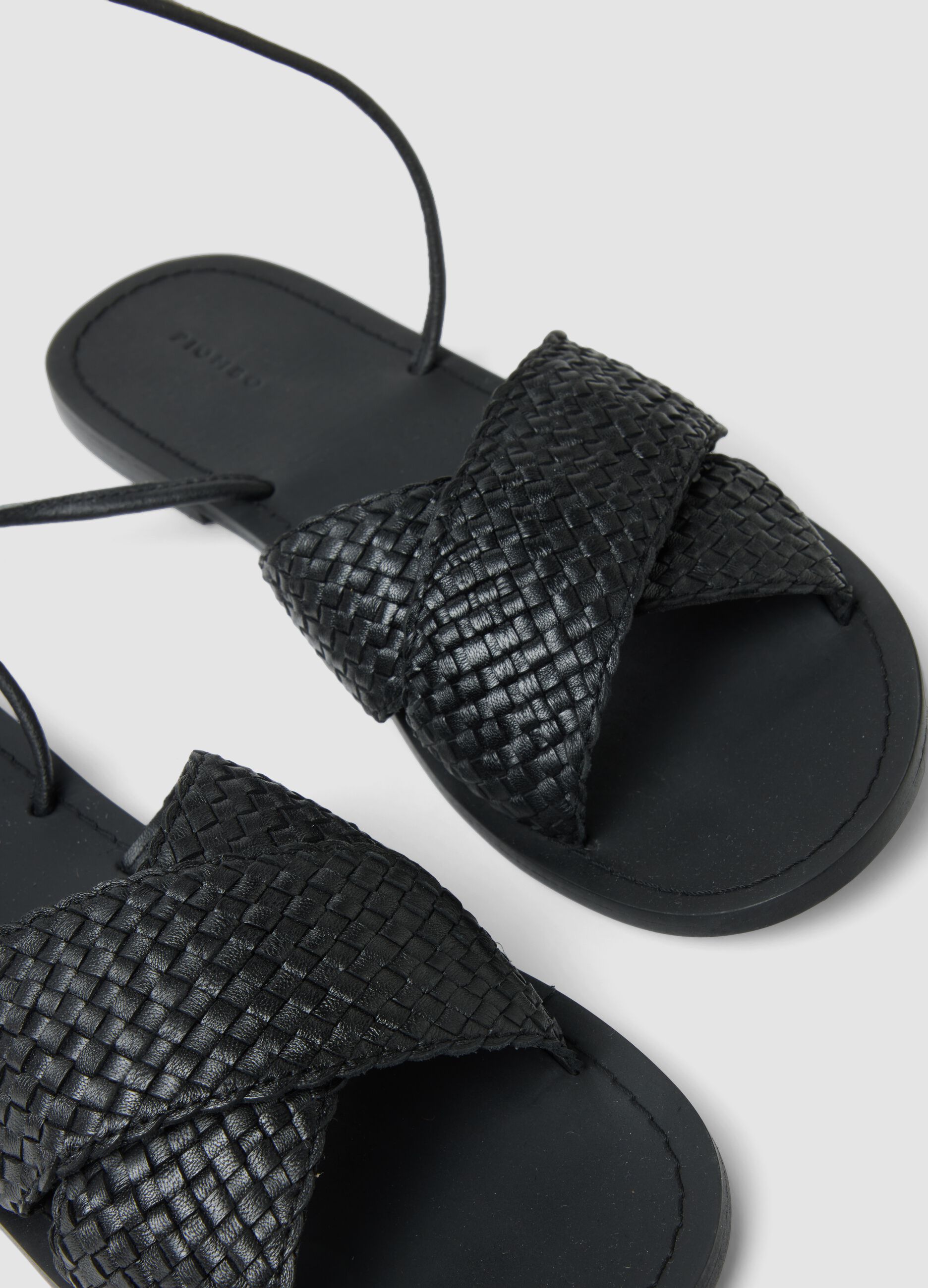 Black woven sandals with ankle ties