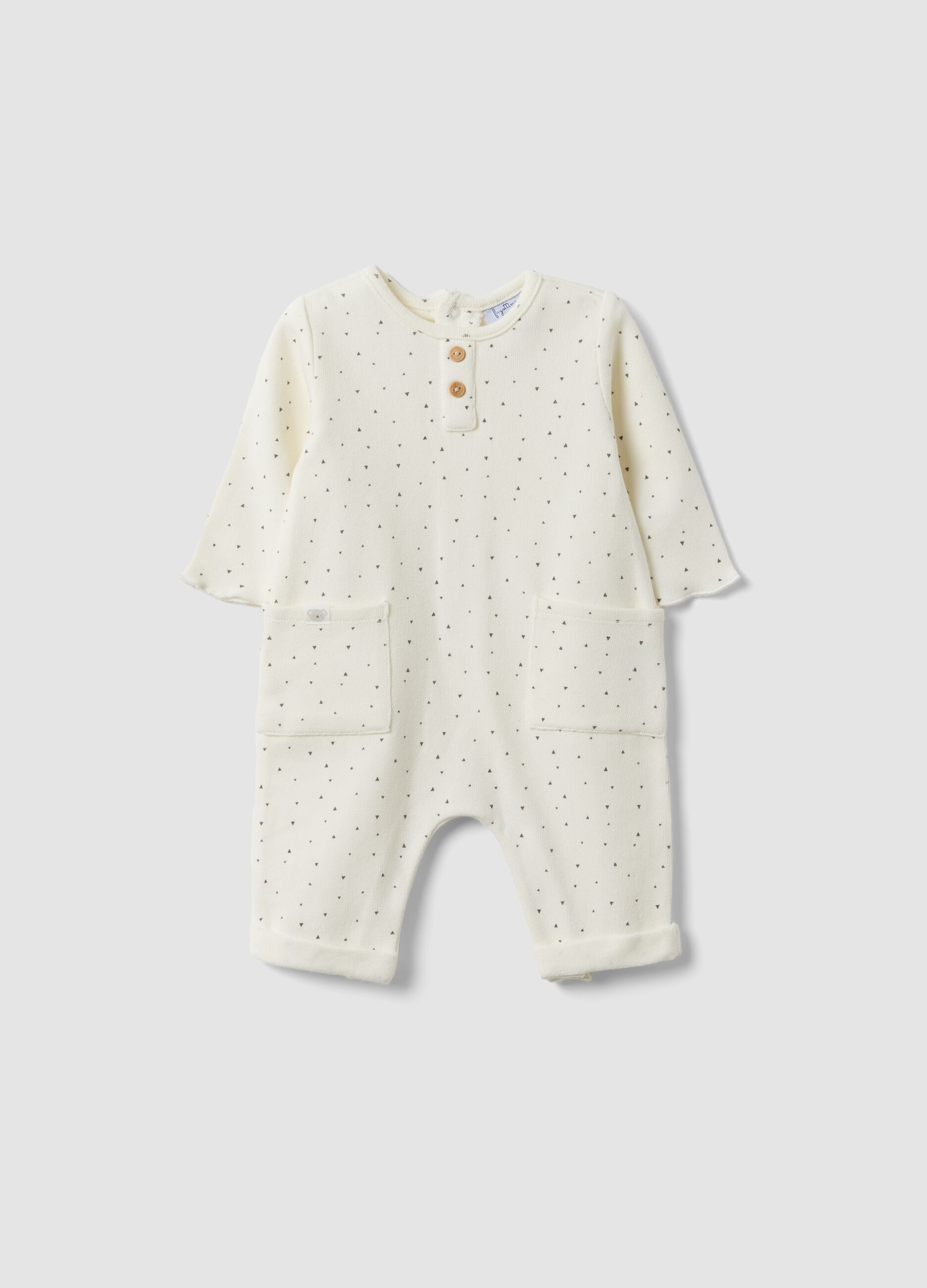 White organic cotton baby romper with buttons and pattern