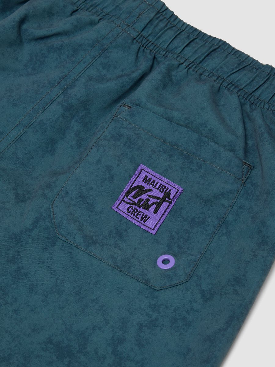 Blue swim shorts with print_3