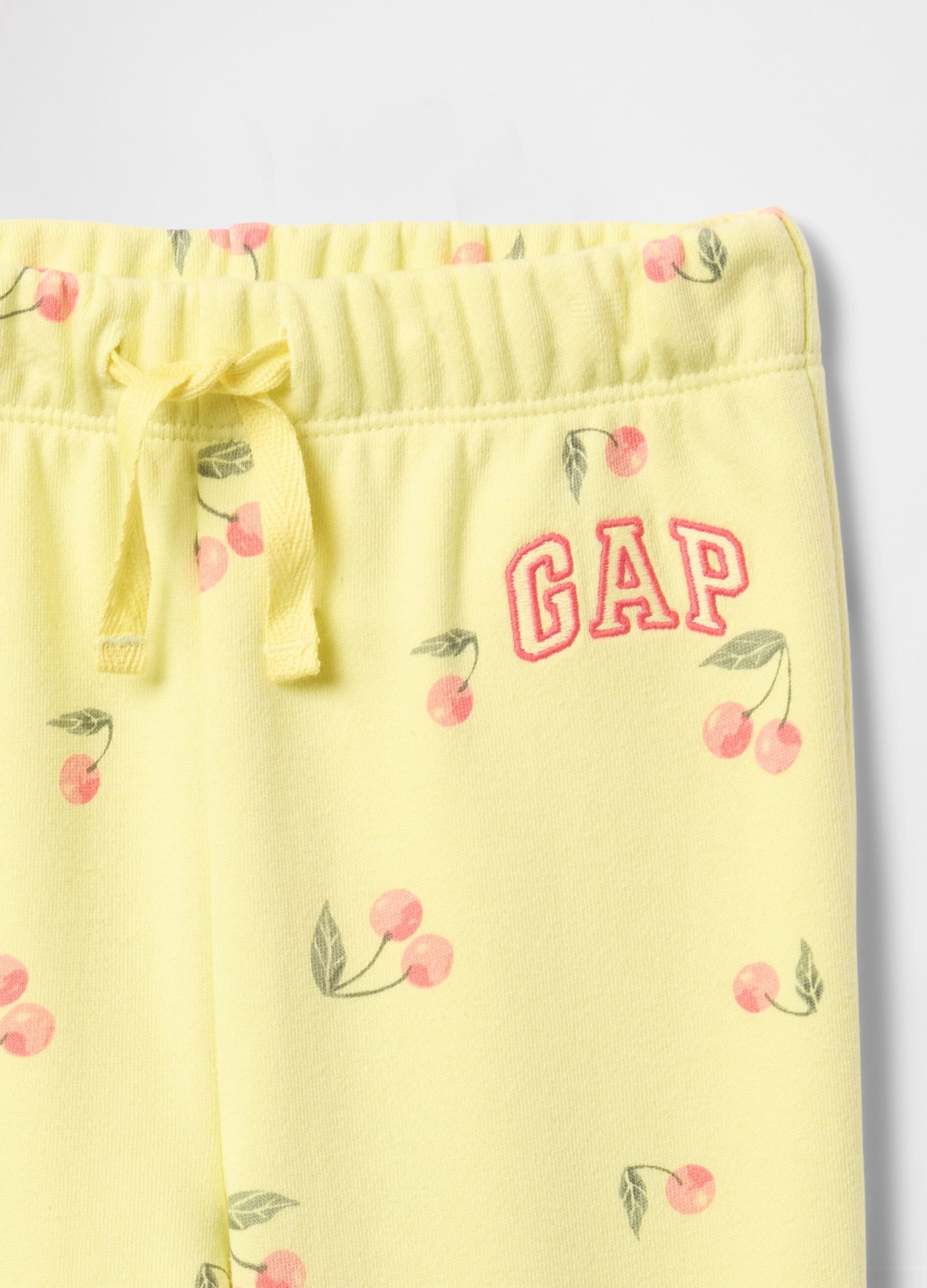 Yellow joggers with drawstring, logo embroidery and cherries print