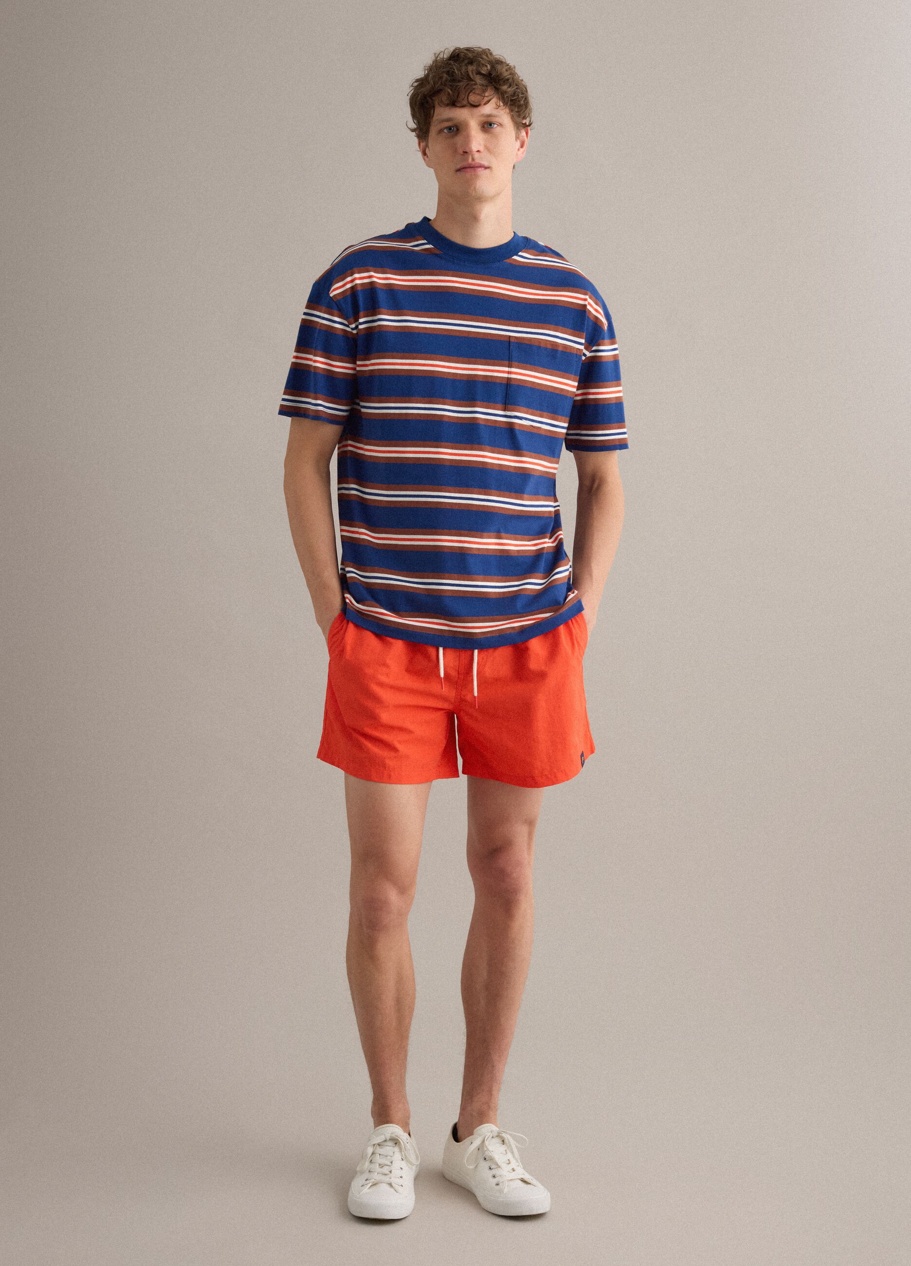 Orange swim shorts with elasticated waistband and drawstring