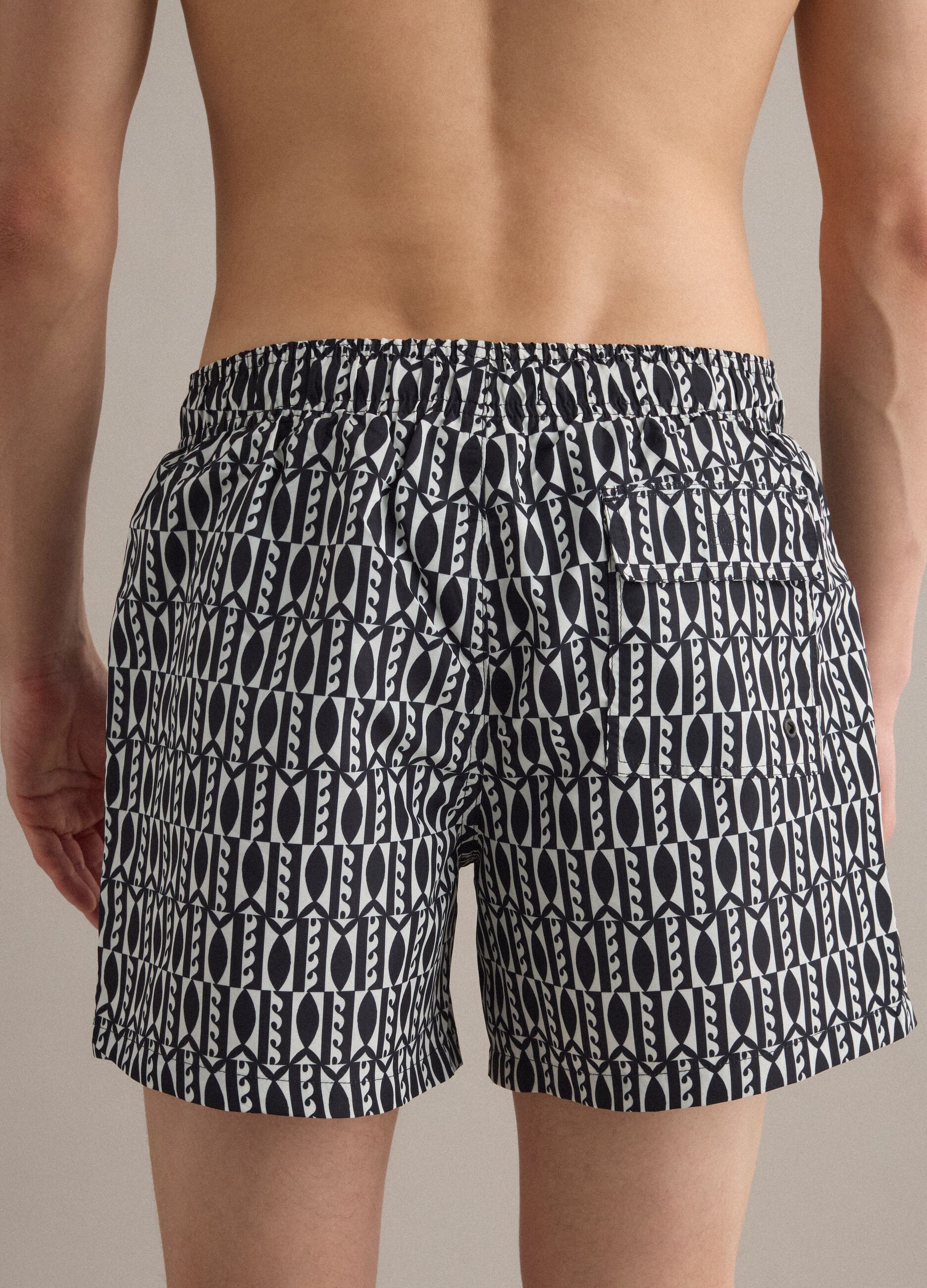 Blue swim shorts with graphic print