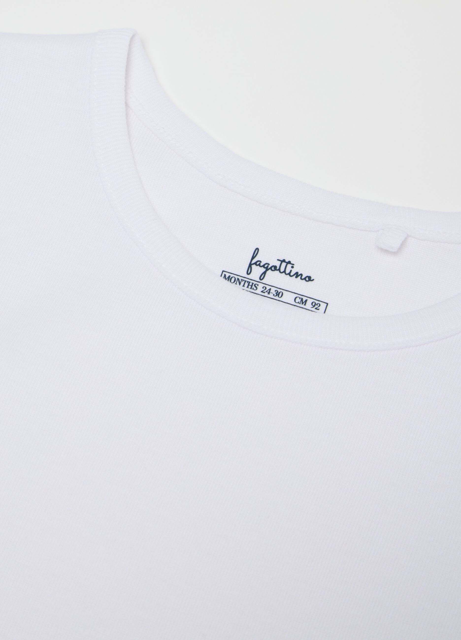 Three-pack white sleeveless bodysuits in organic cotton