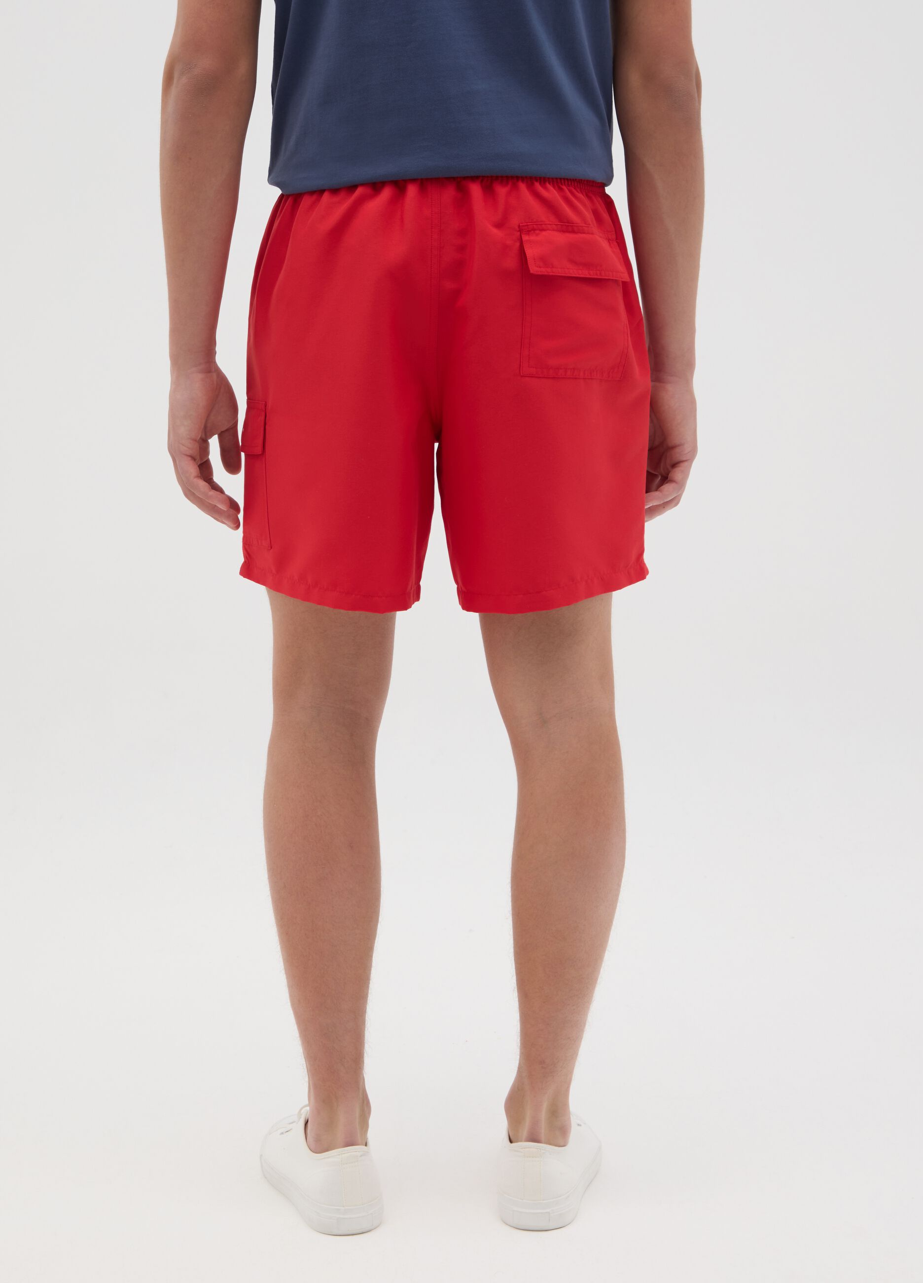Red swimming trunks with logo print
