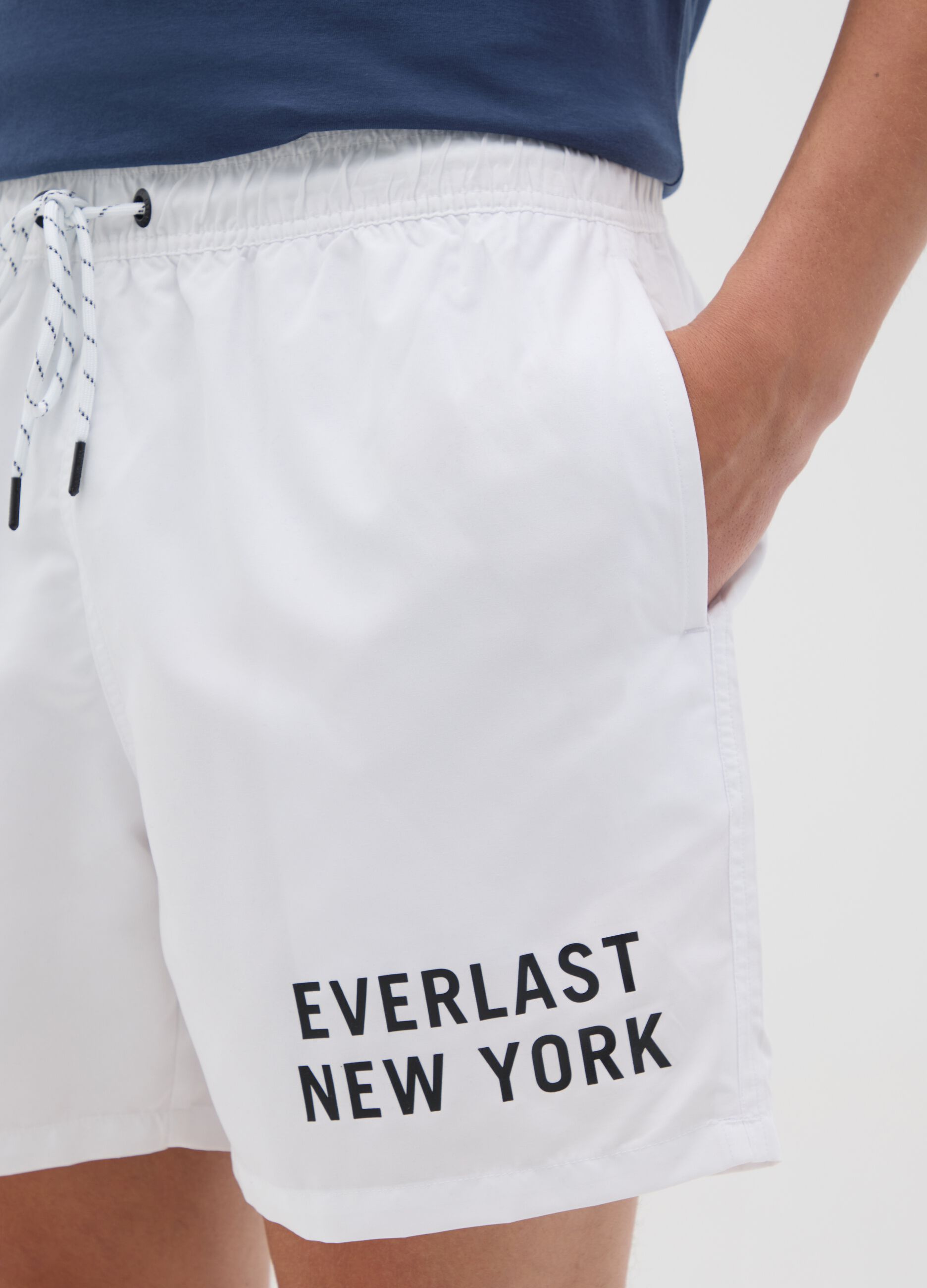 White swimming trunks with logo print