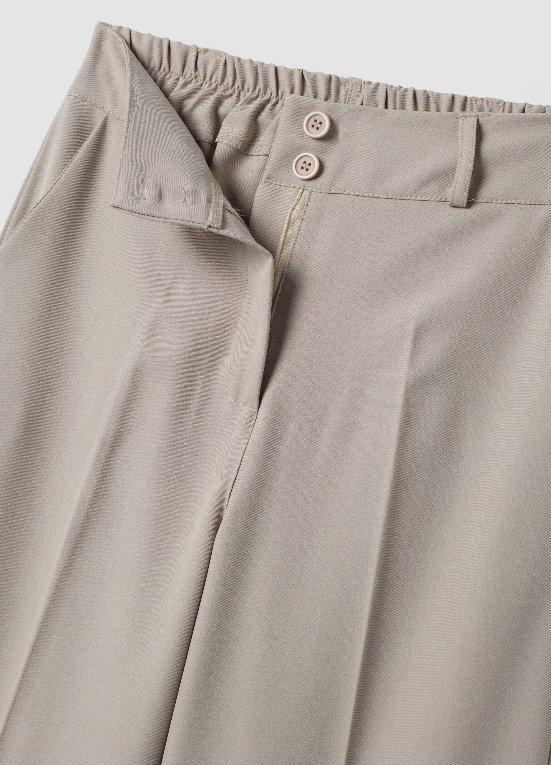 Beige stretch trousers with turn-up hem