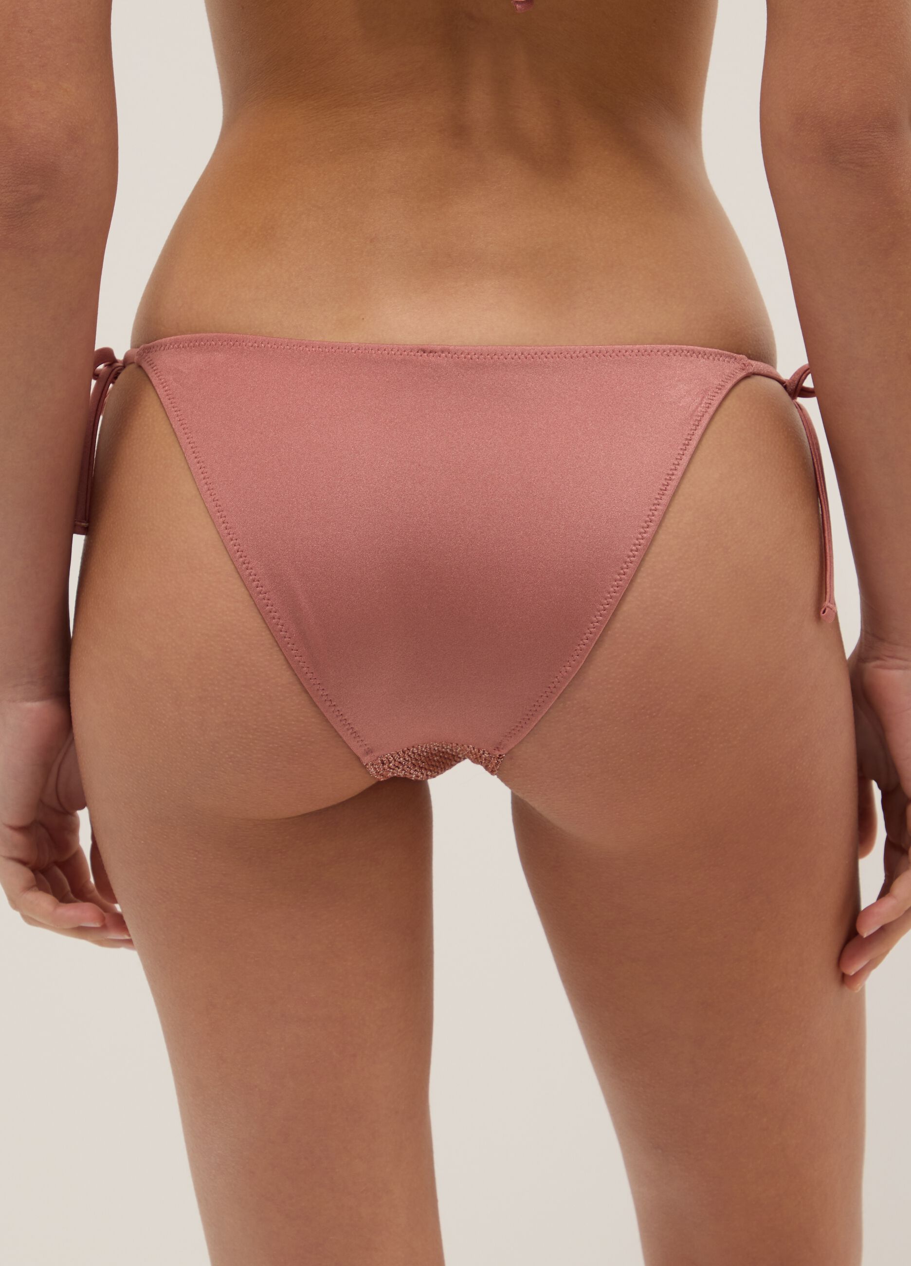 Pink bikini bottoms with metallic crochet side ties