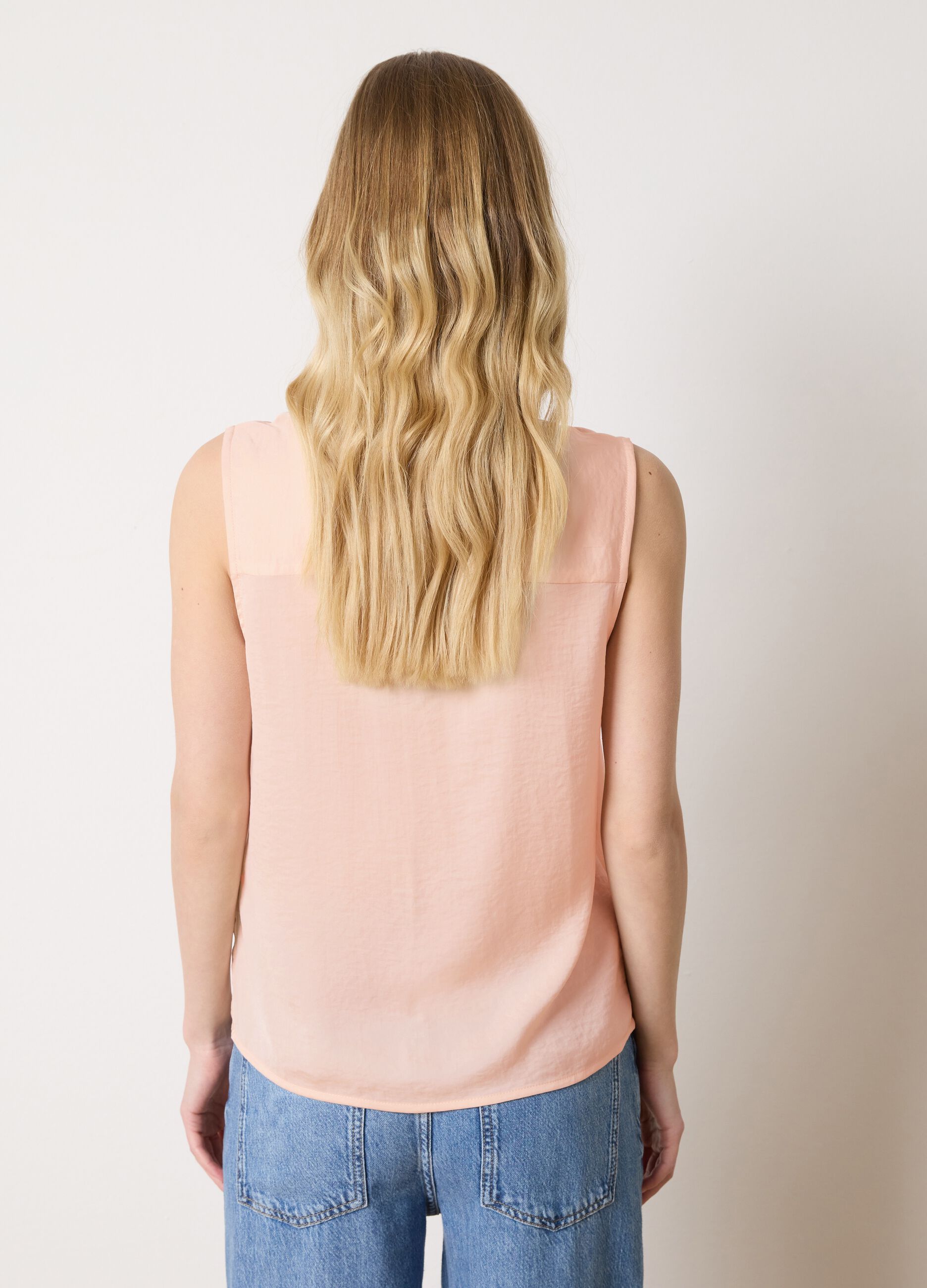 Pink sleeveless blouse with flounce