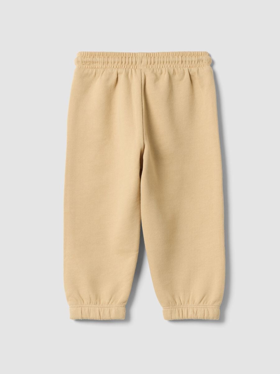 Pantaloni jogger beige in puro cotone con stampa_1