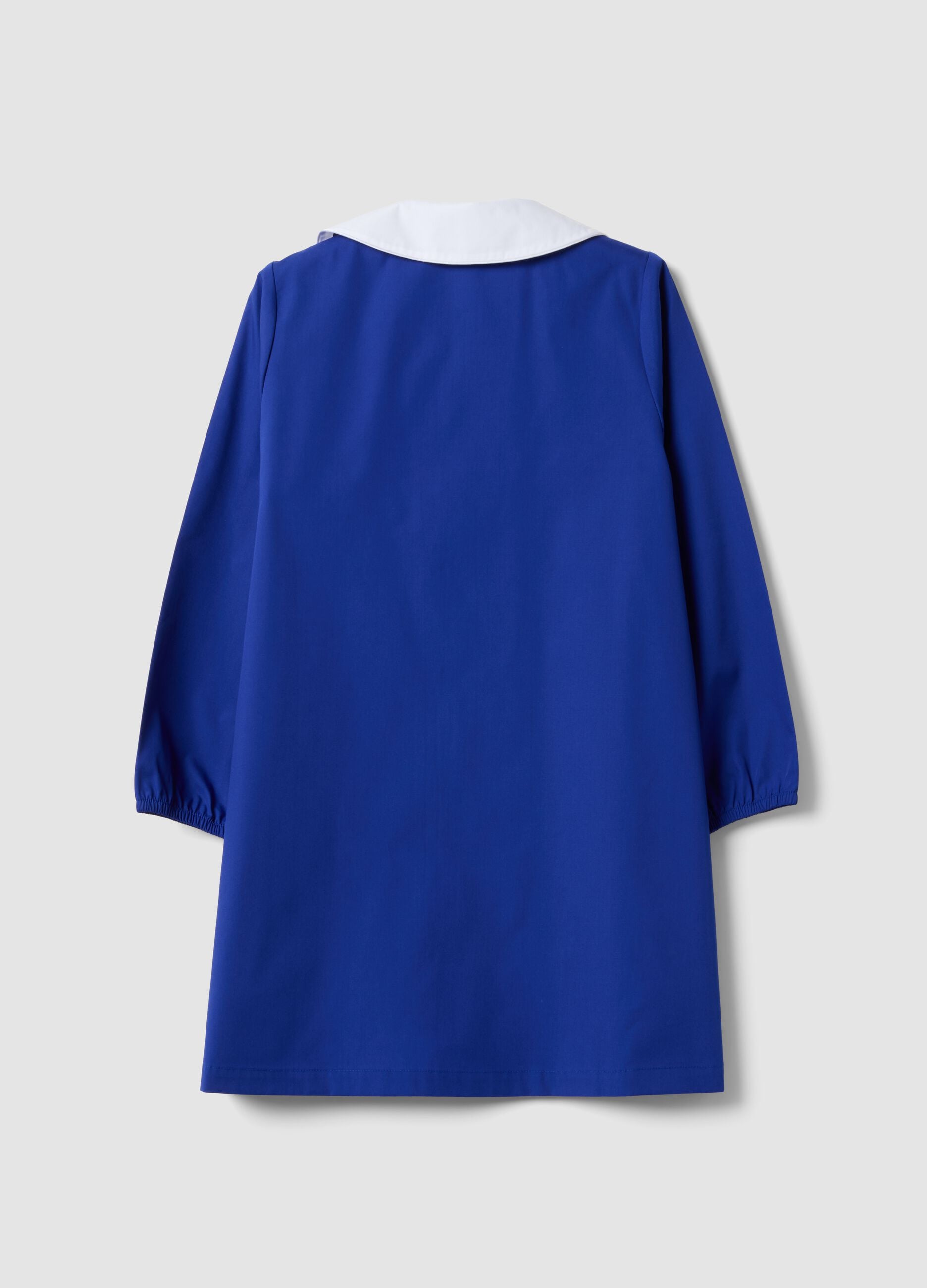 Blue girls&rsquo; school apron with white collar and Stitch embroidery