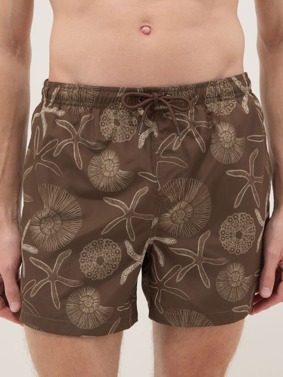Brown swim shorts with seashell and starfish print_1