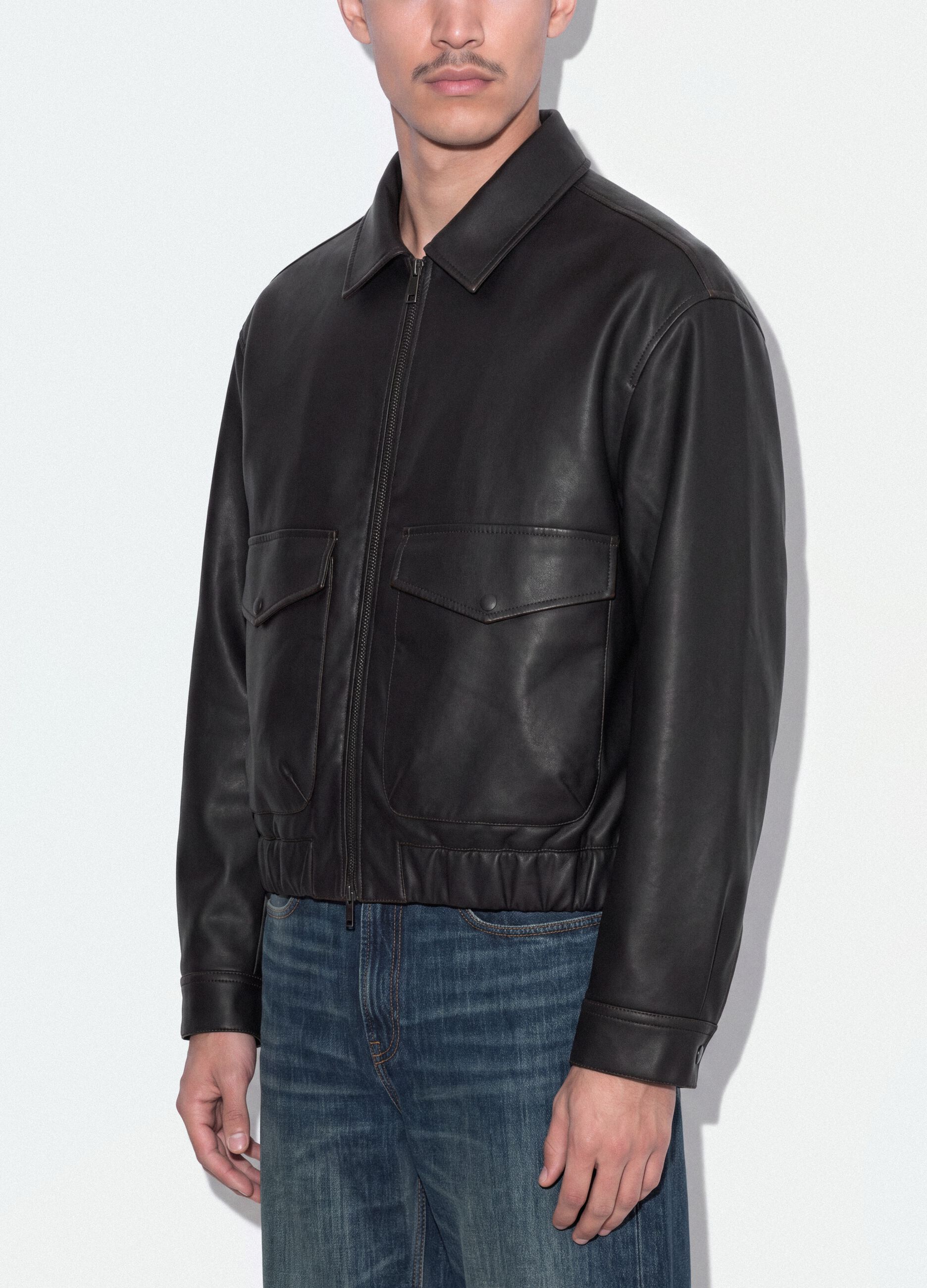 Black cropped jacket with zip and flap pockets, oversized fit