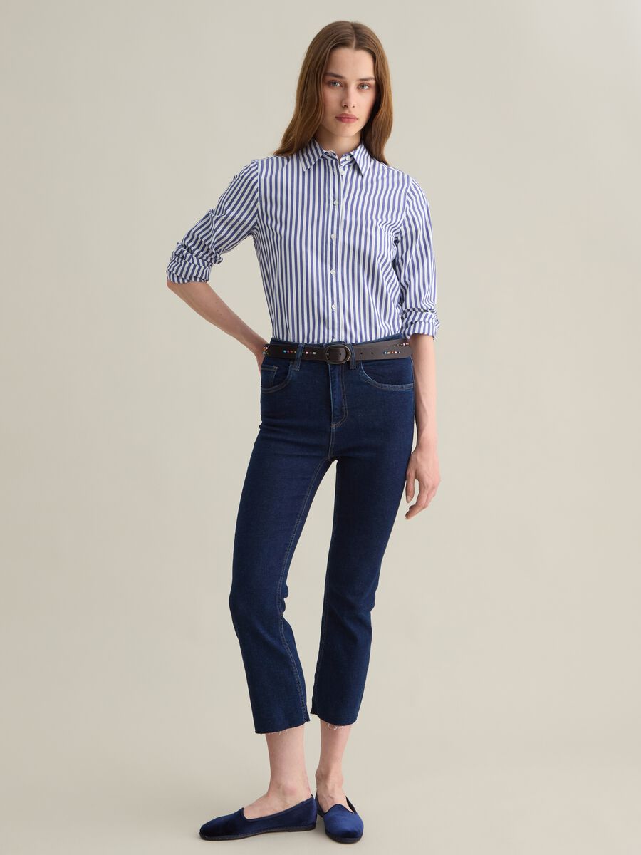 Cropped blue flare-fit jeans with raw edging_0