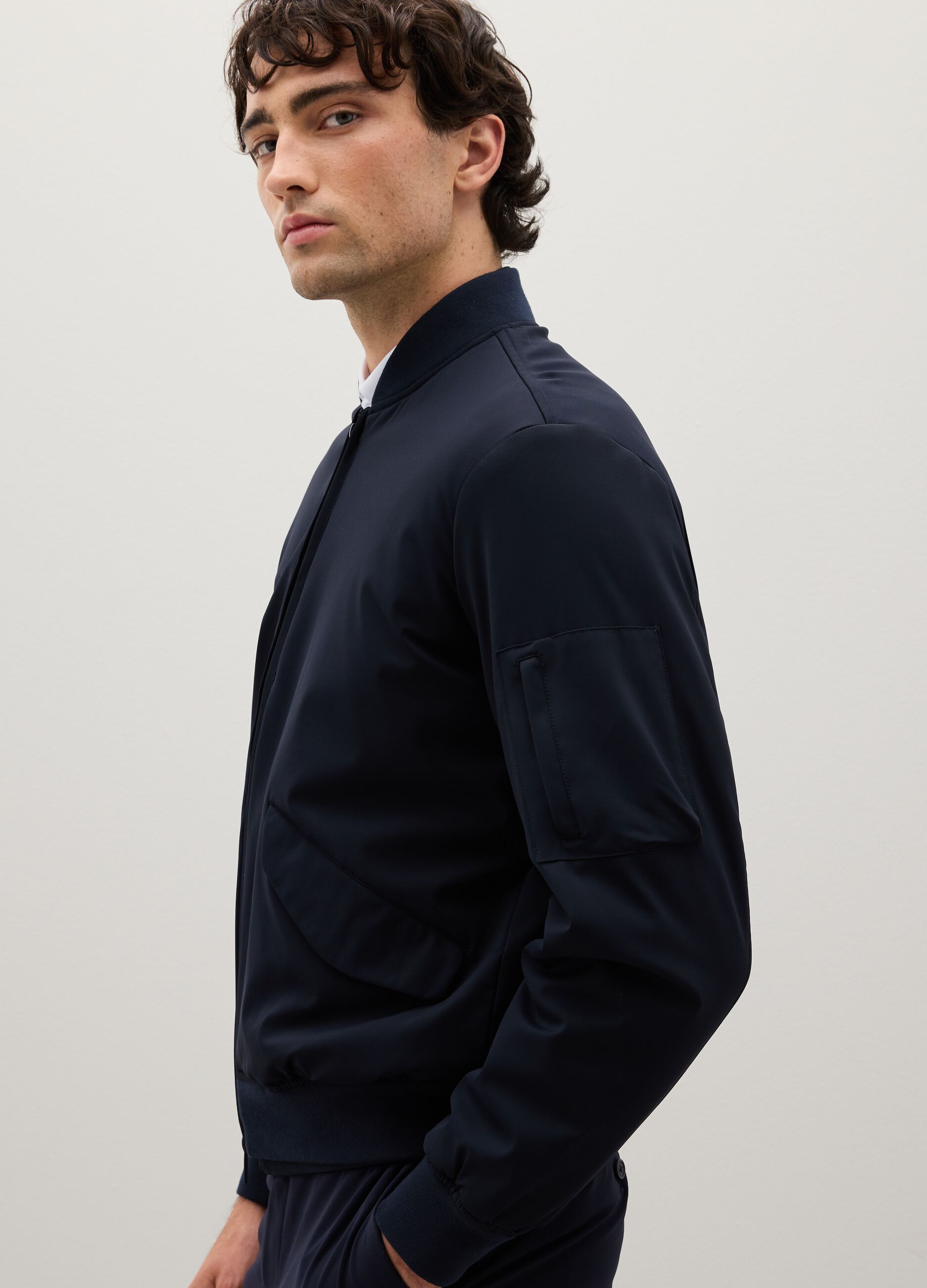 Stretch blue bomber with zip closure