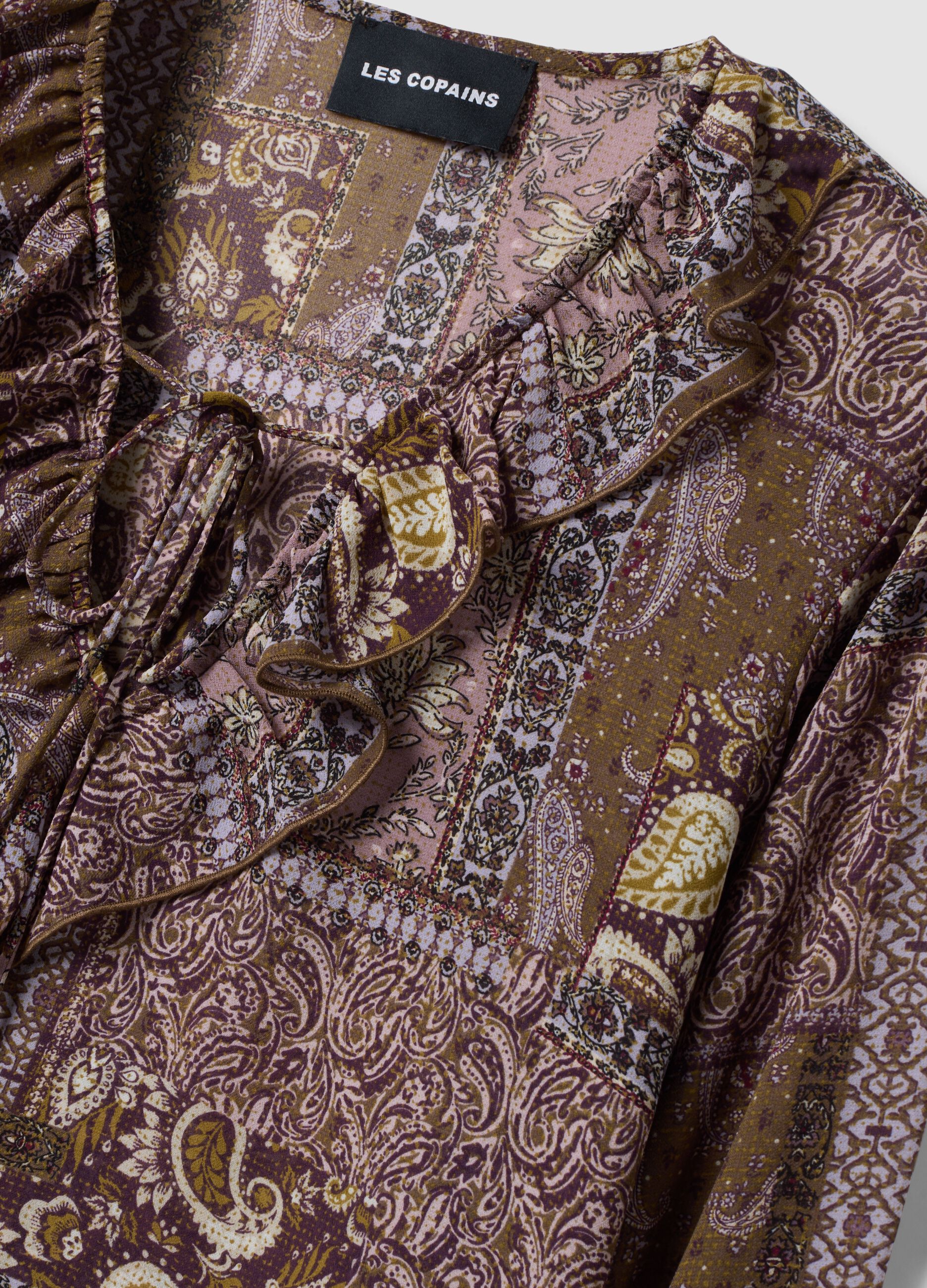 Purple patterned blouse with ruffles and tie neck