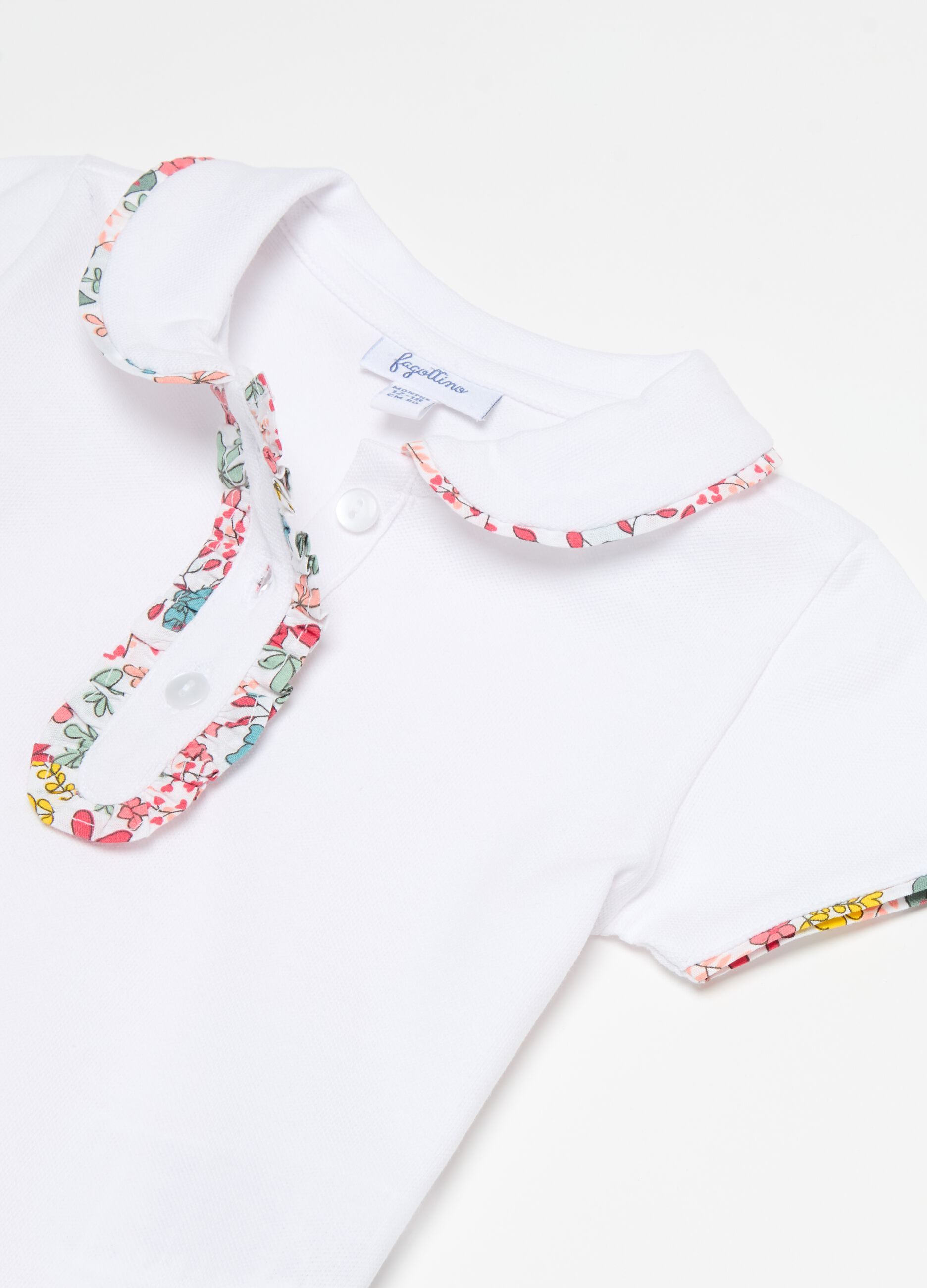 Polo shirt in piquet with floral patterned trims