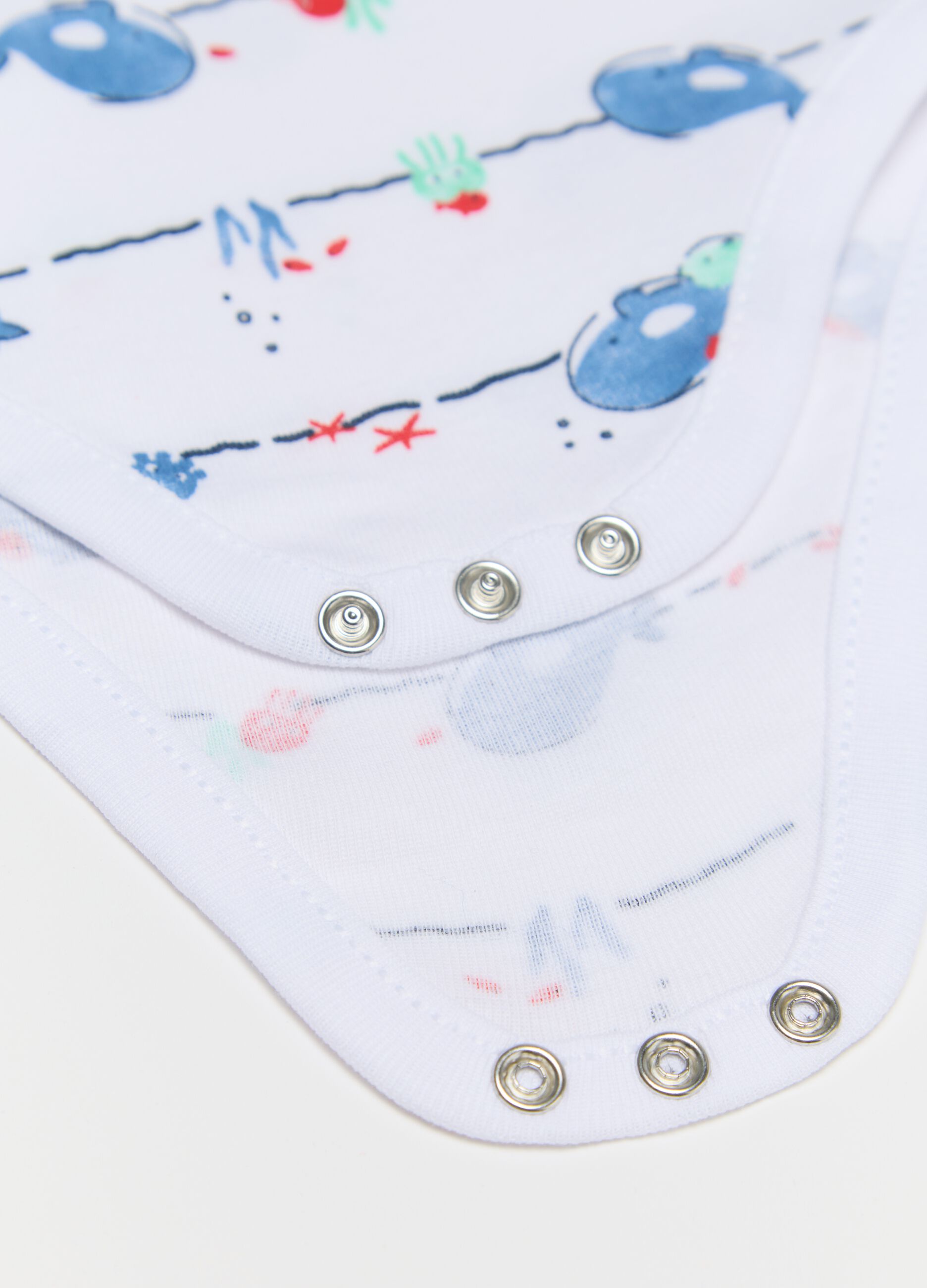 Three-pack sleeveless blue and white bodysuits in organic cotton with print